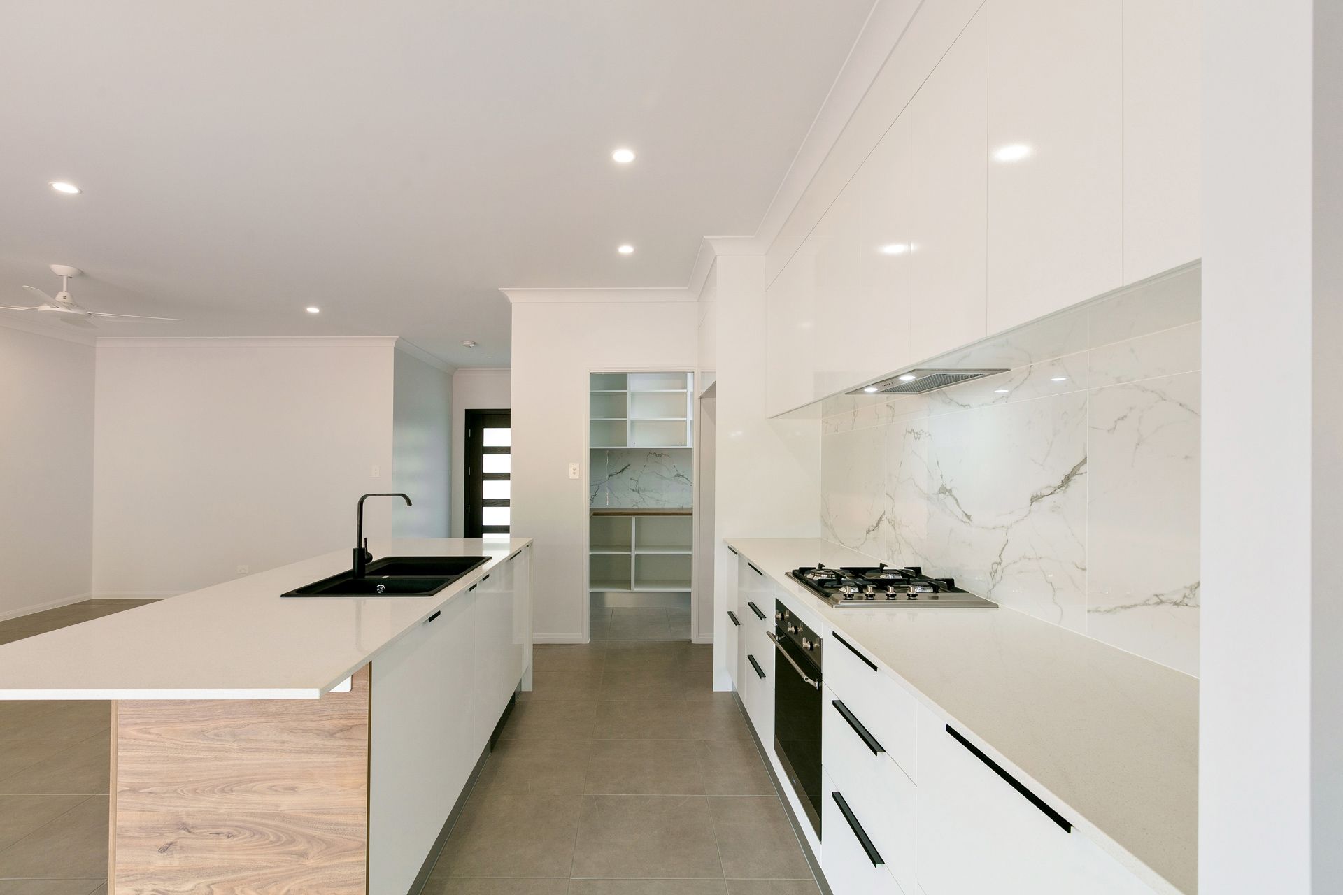 Modern White Kitchen With a Marble Backsplash — Ashlee Jones Homes in Gordonvale, QLD