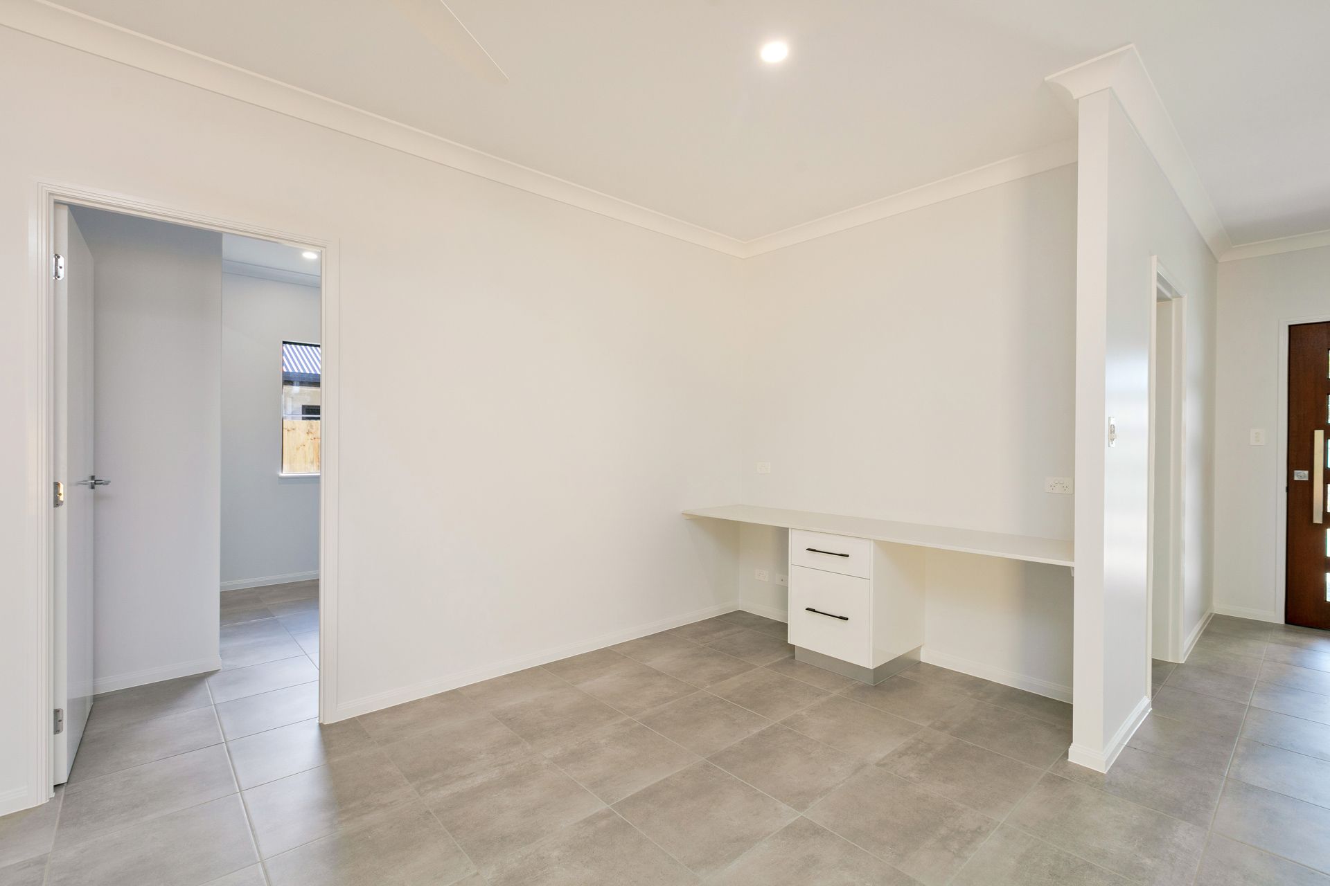 A Bright, Minimalist Office Nook Featuring a Built-in White Desk — Ashlee Jones Homes in Gordonvale, QLD