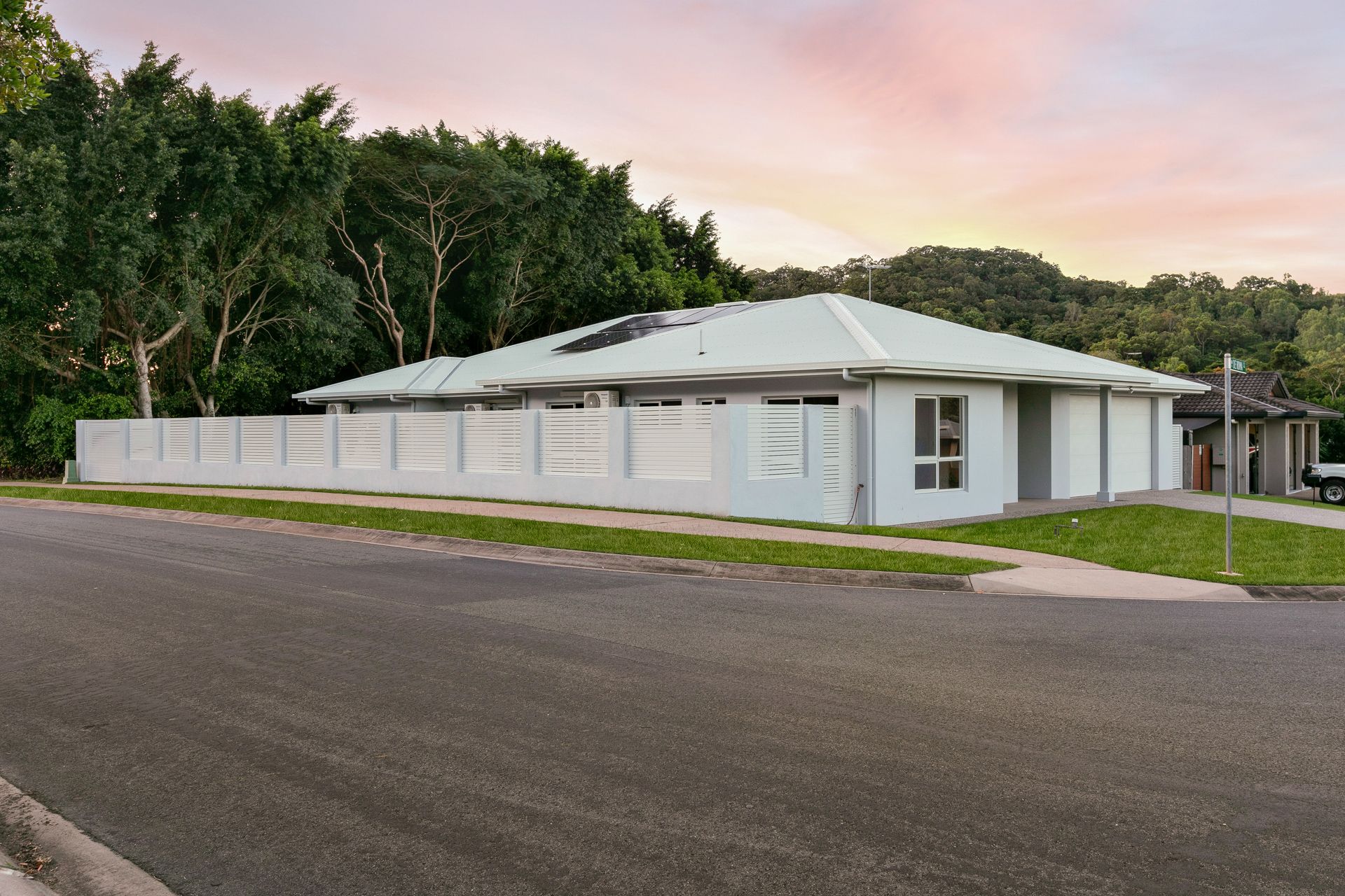 A Modern, Single-story, Light-colored House With a Fence — Ashlee Jones Homes in Gordonvale, QLD