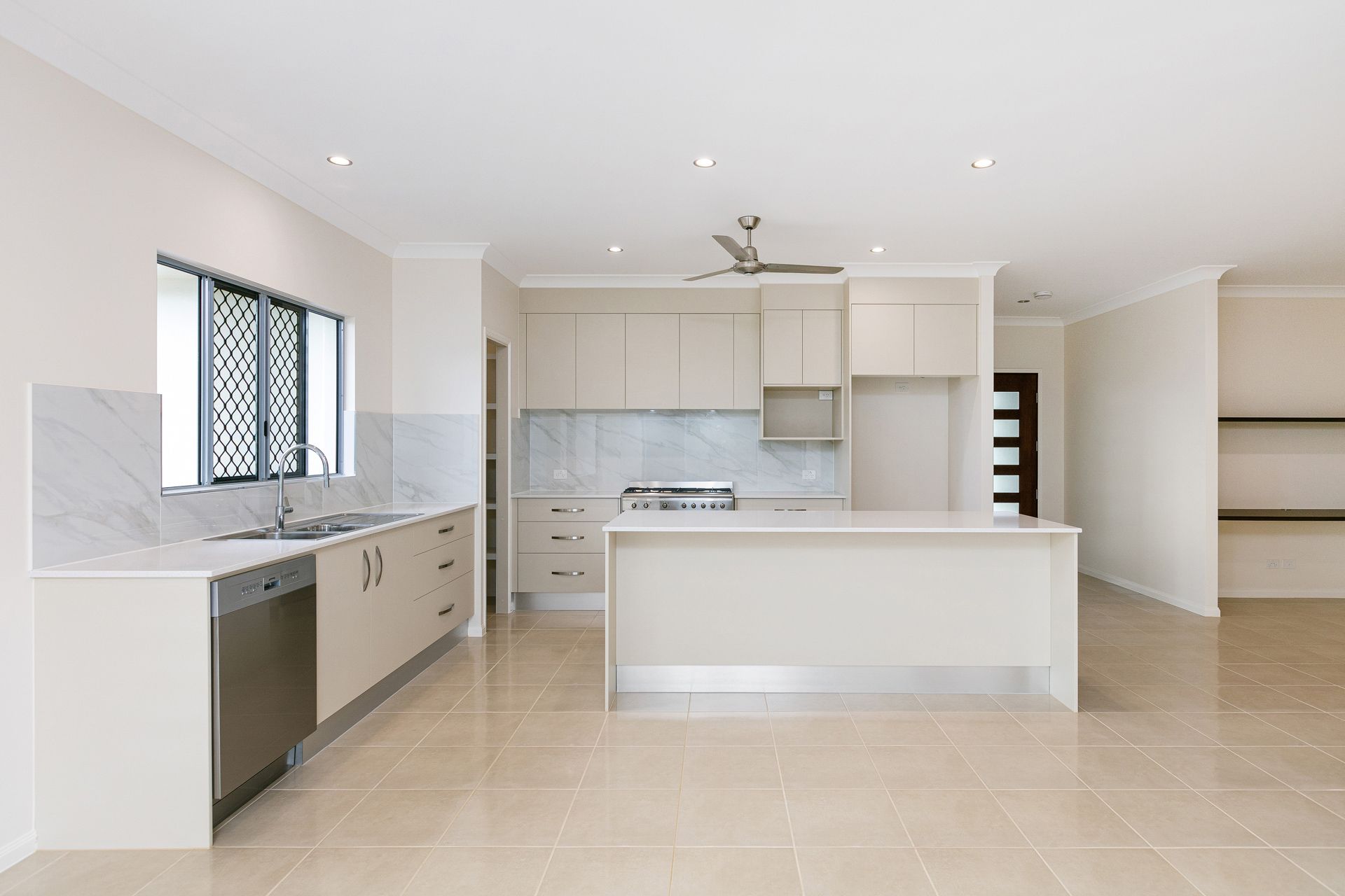 Modern, Bright Kitchen With Beige Cabinetry — Ashlee Jones Homes in Gordonvale, QLD