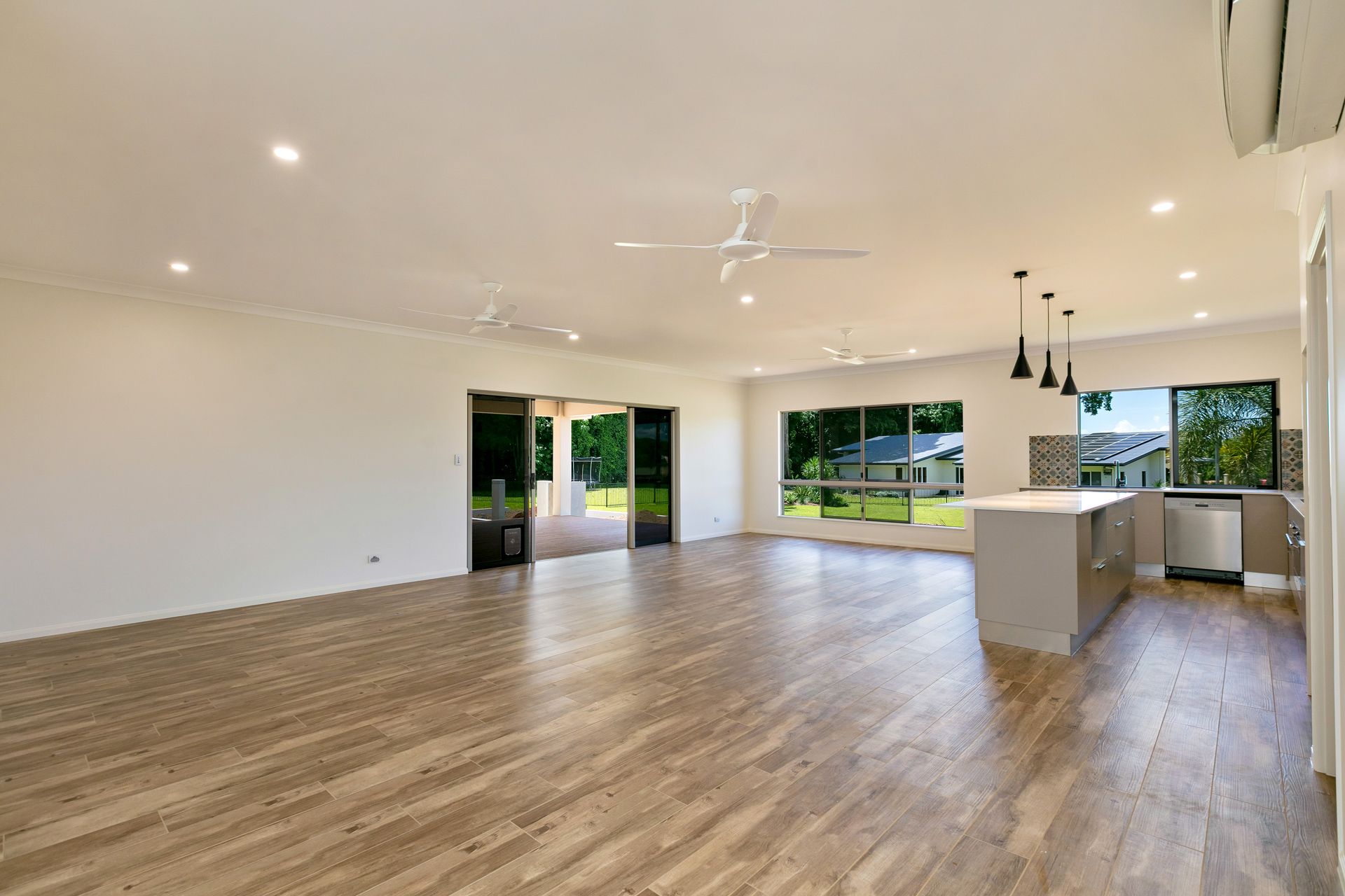 A Bright, Open-plan Room With Wood-look Flooring — Ashlee Jones Homes in Gordonvale, QLD