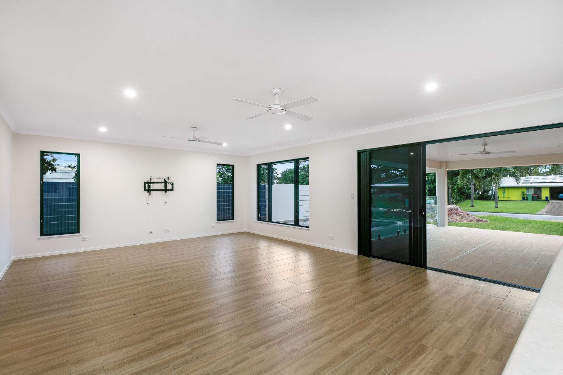 An Empty Room With Light Wood Flooring — Ashlee Jones Homes in Gordonvale, QLD