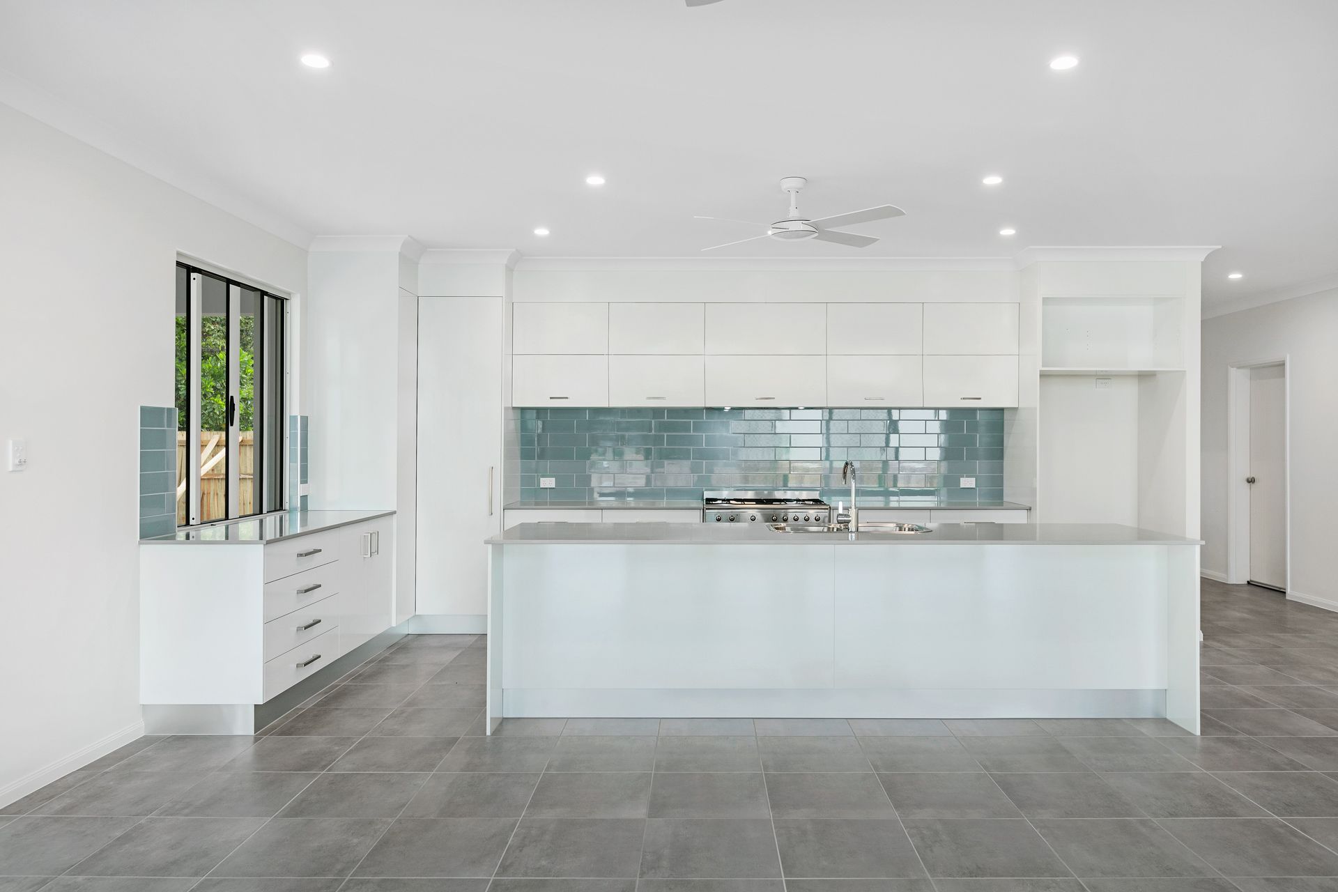 Modern, Minimalist White Kitchen With a Large Island — Ashlee Jones Homes in Gordonvale, QLD