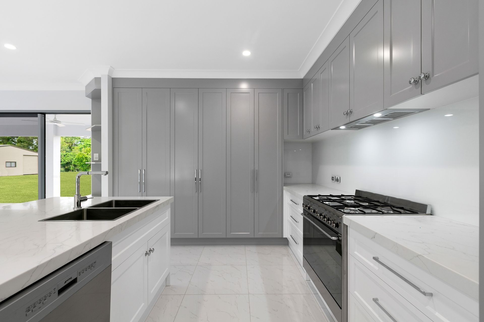 Modern Kitchen With Grey Cabinetry, White Countertops — Ashlee Jones Homes in Gordonvale, QLD