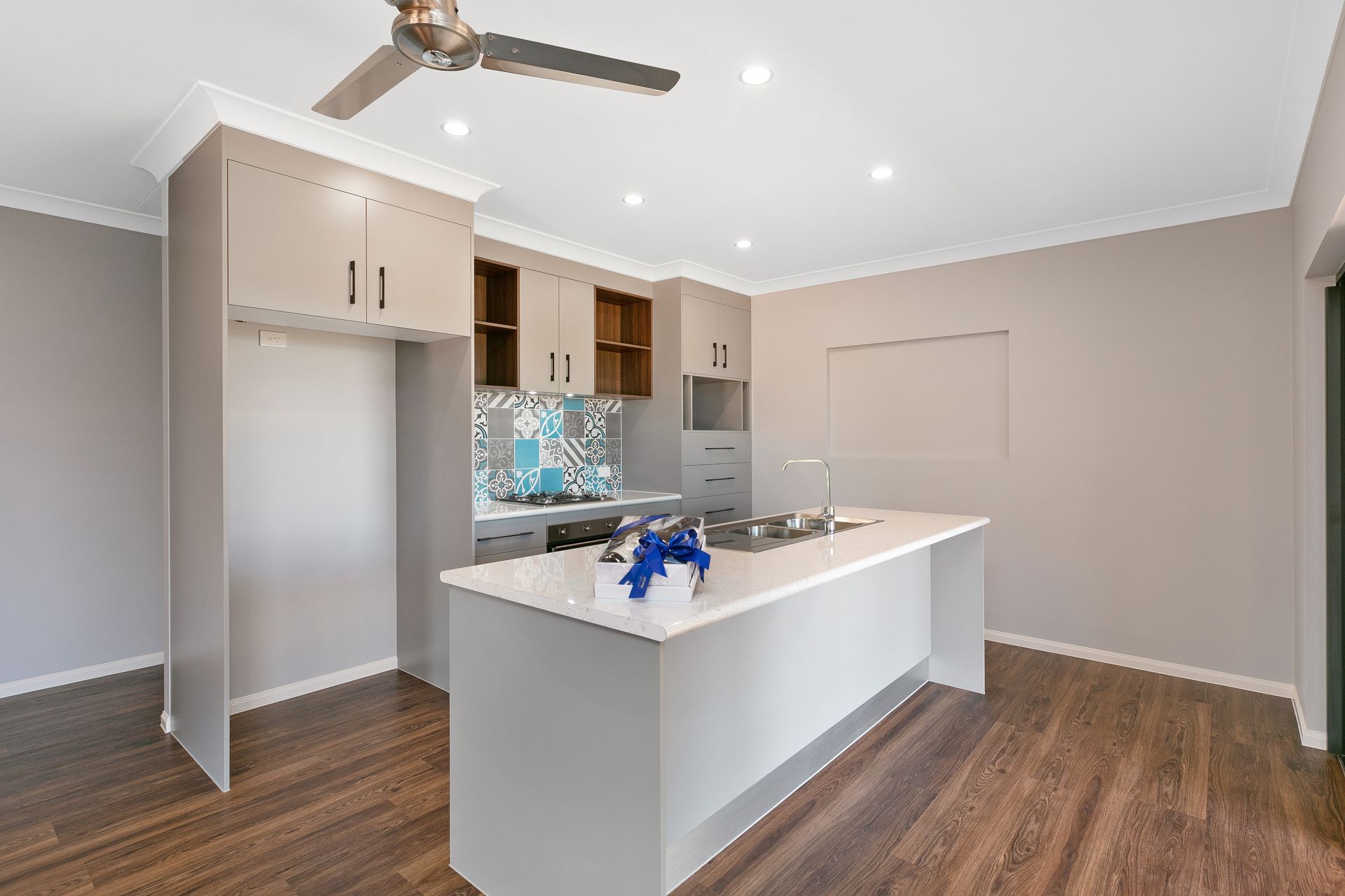 A Modern Kitchen With Light Grey Cabinets — Ashlee Jones Homes in Gordonvale, QLD