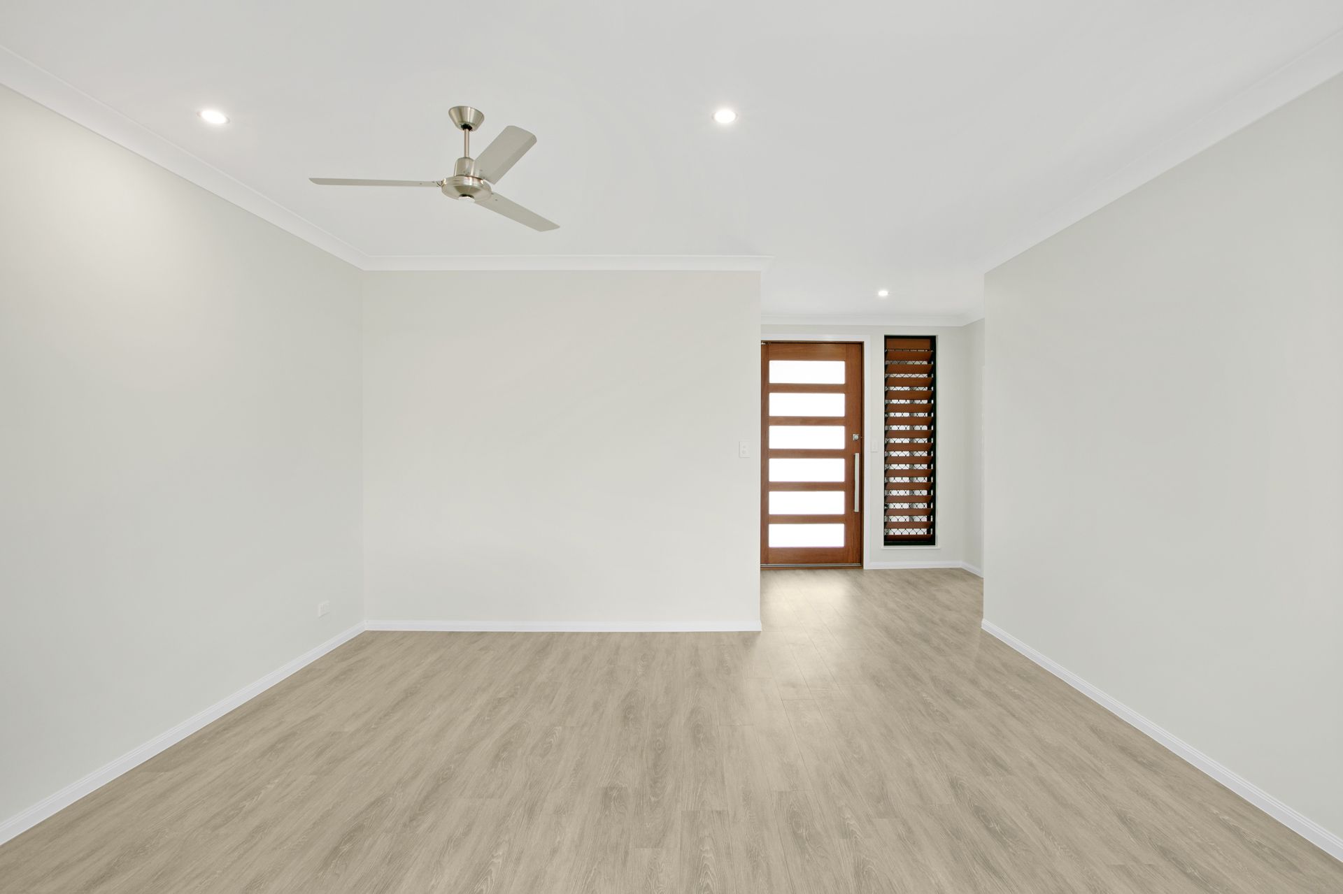 Empty Modern Room With Light Wood Flooring — Ashlee Jones Homes in Gordonvale, QLD
