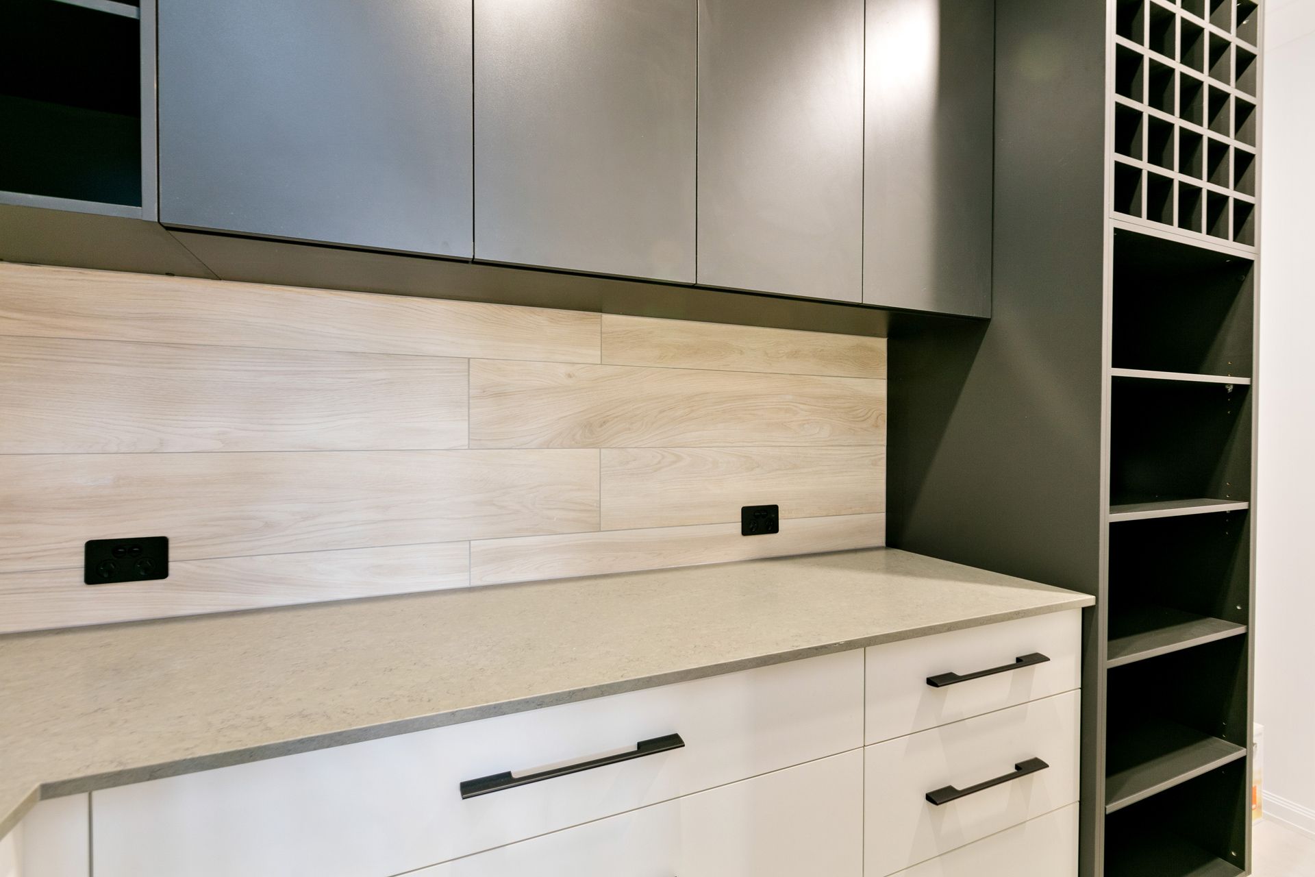 Modern Kitchen Counter With Light Wood-look Backsplash — Ashlee Jones Homes in Gordonvale, QLD