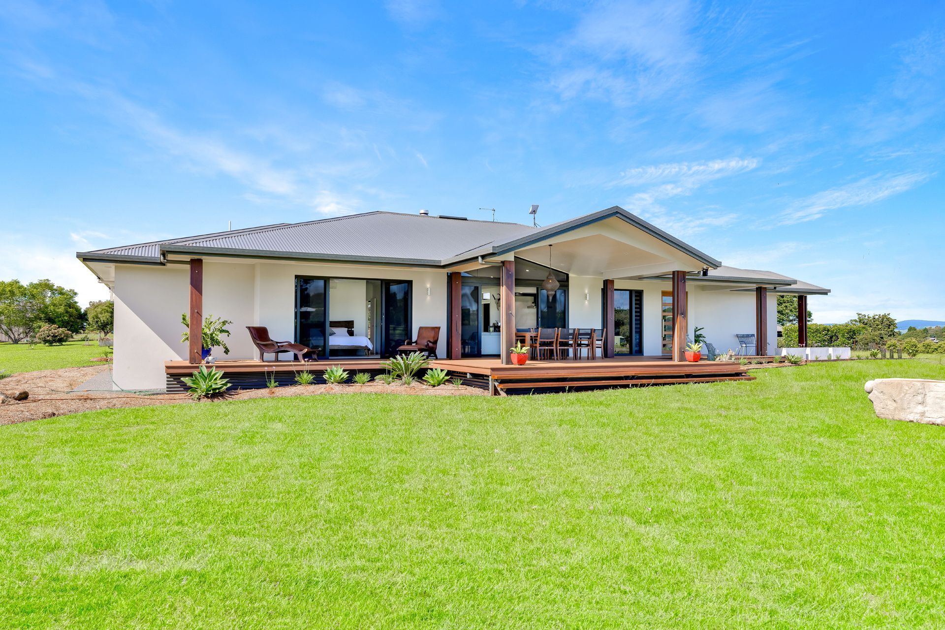 A Single-story, Light-colored House With a Dark Tiled Roof — Ashlee Jones Homes in Gordonvale, QLD