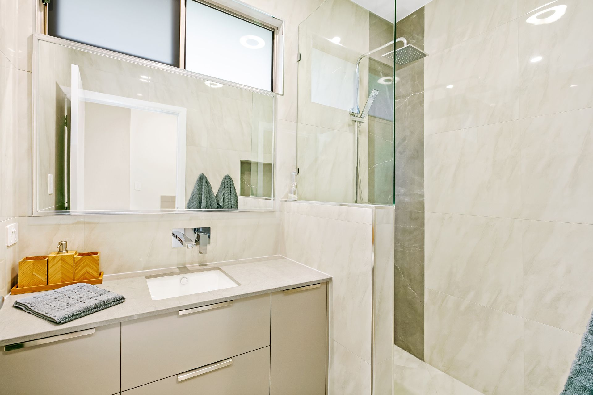 A Modern Bathroom Featuring a Floating Vanity With a Sink — Ashlee Jones Homes in Gordonvale, QLD
