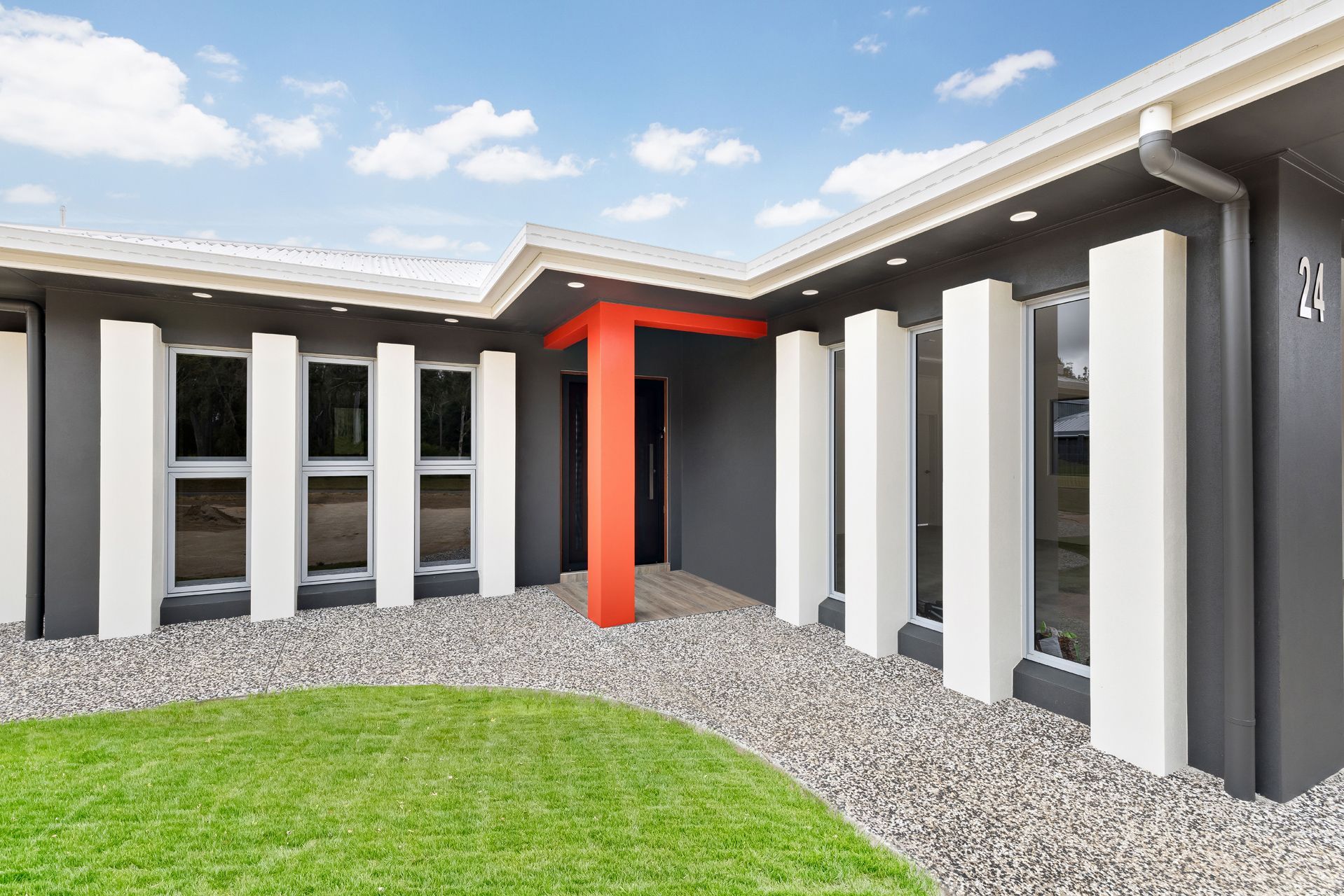 A Modern House Exterior With Dark Gray Walls — Ashlee Jones Homes in Gordonvale, QLD