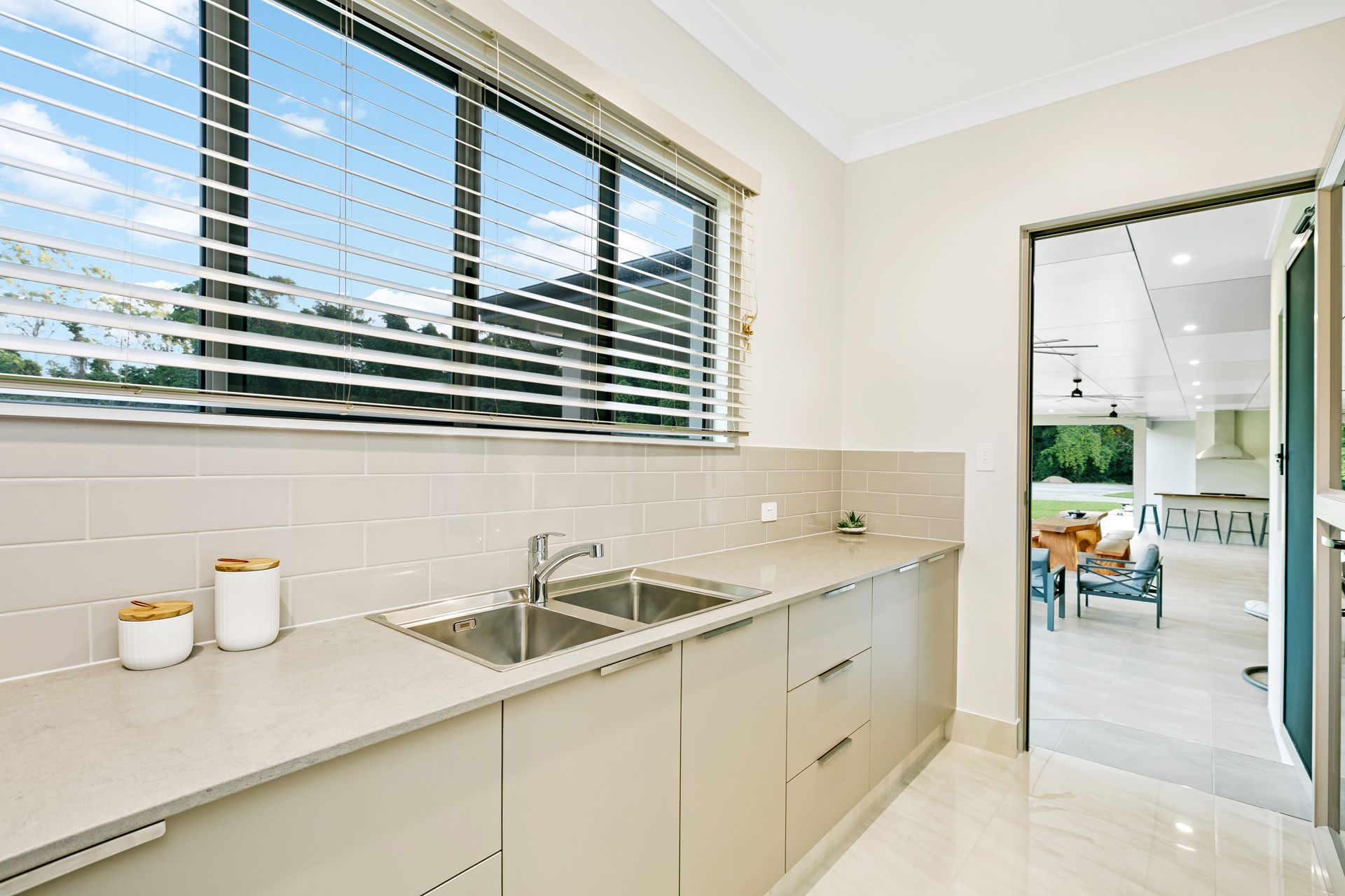 Modern Kitchen With Beige Cabinets, a Stainless Steel Sink — Ashlee Jones Homes in Gordonvale, QLD