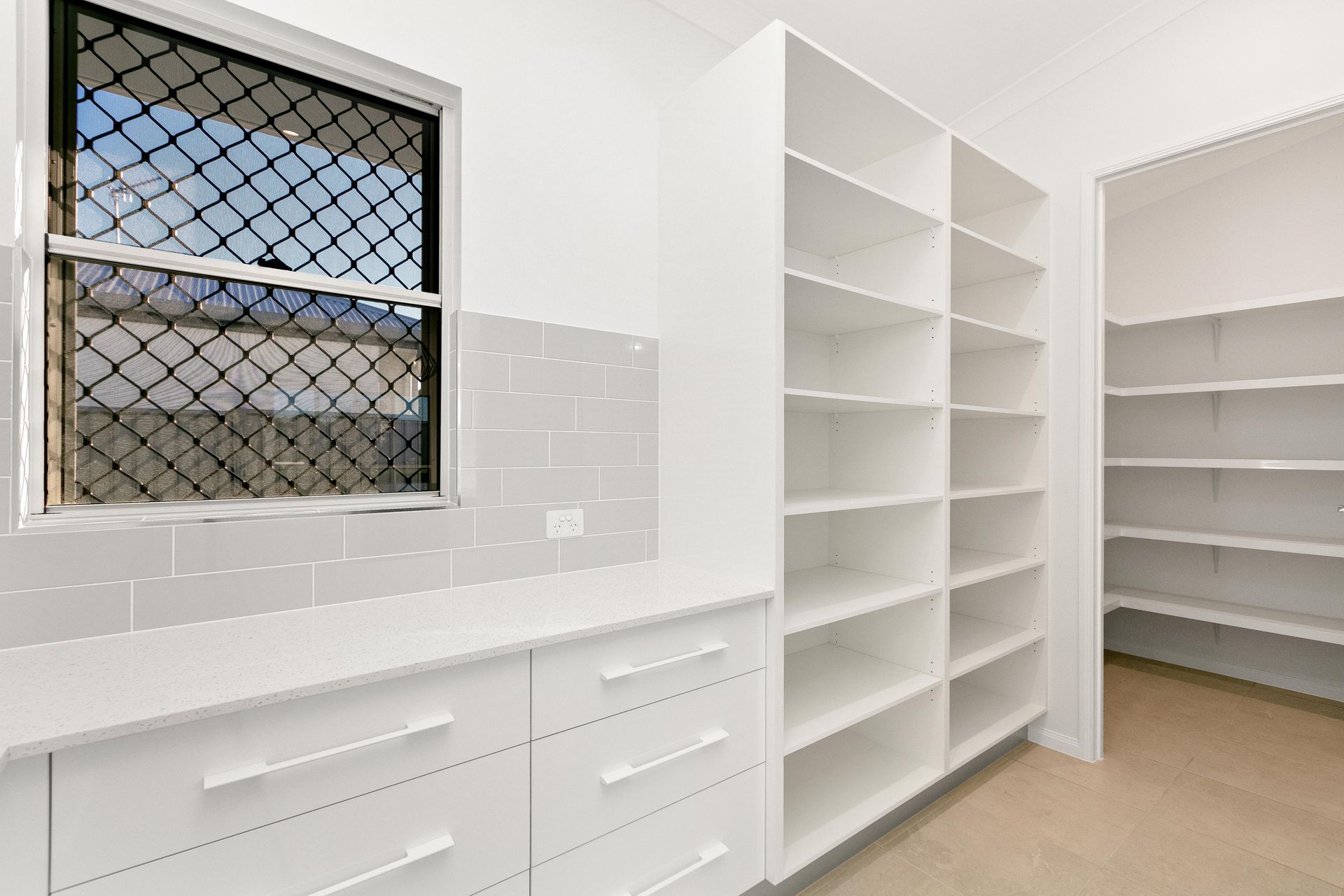 A Bright, Modern Pantry With White Cabinets — Ashlee Jones Homes in Gordonvale, QLD