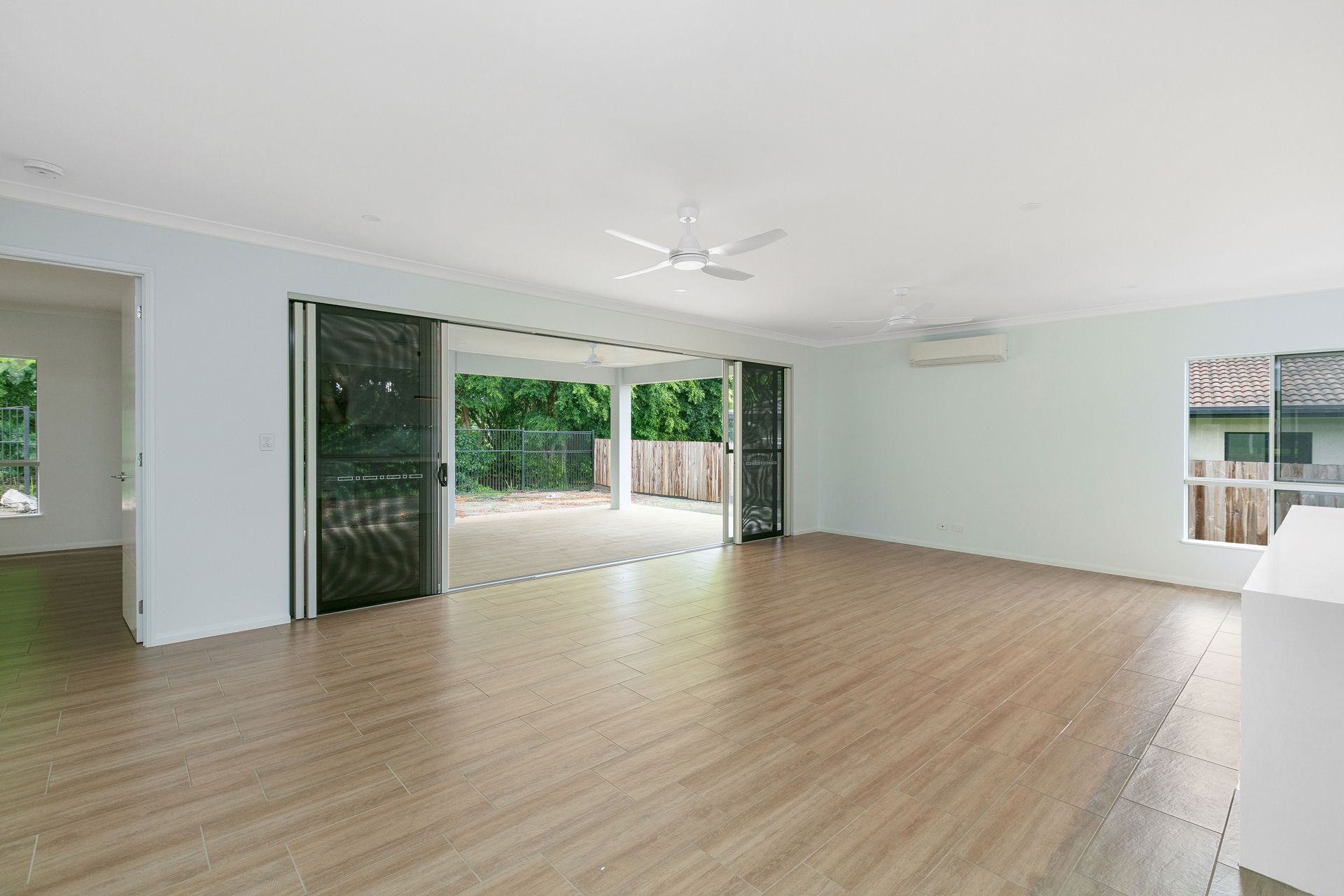 An Airy, Open-plan Room With Light-colored Wood Flooring — Ashlee Jones Homes in Gordonvale, QLD