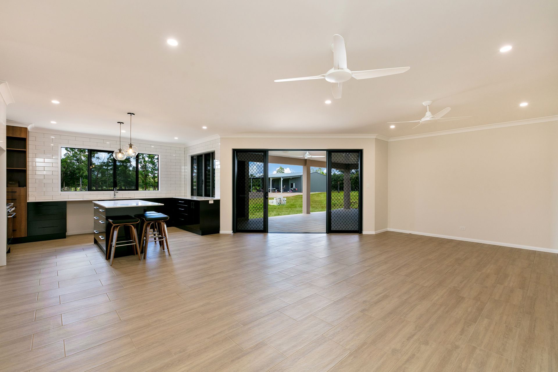 Modern Open-plan Kitchen and Living Area With Light Wood Floors — Ashlee Jones Homes in Gordonvale, QLD