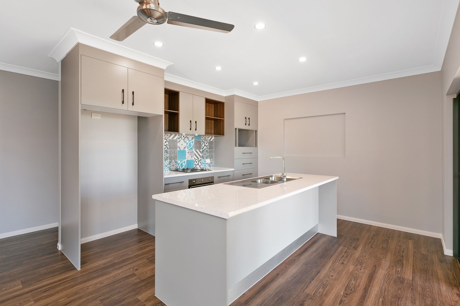 Modern Kitchen With Light Grey Cabinets — Ashlee Jones Homes in Gordonvale, QLD