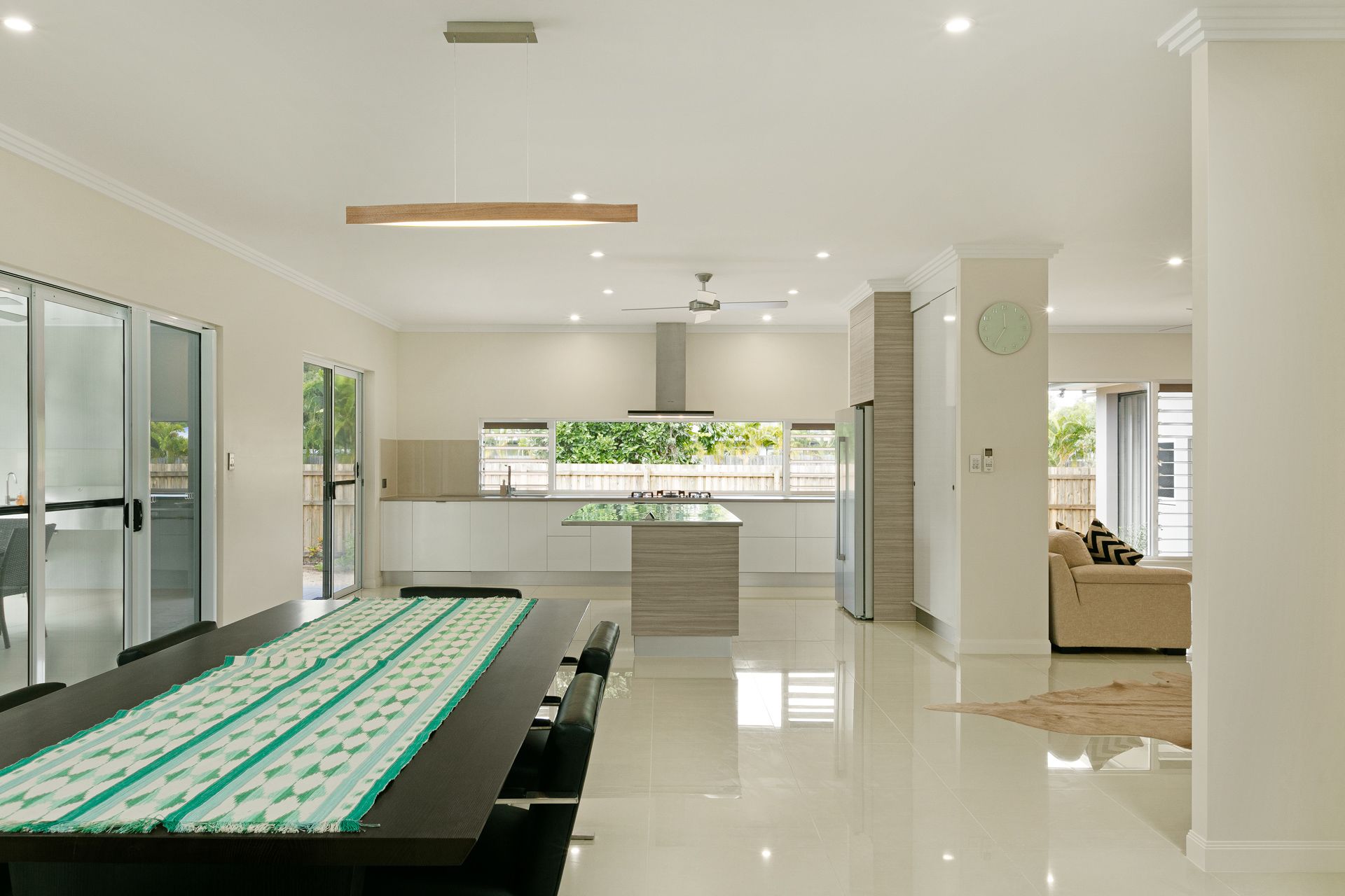 A Long Dining Table With a Green Runner in a Bright — Ashlee Jones Homes in Gordonvale, QLD