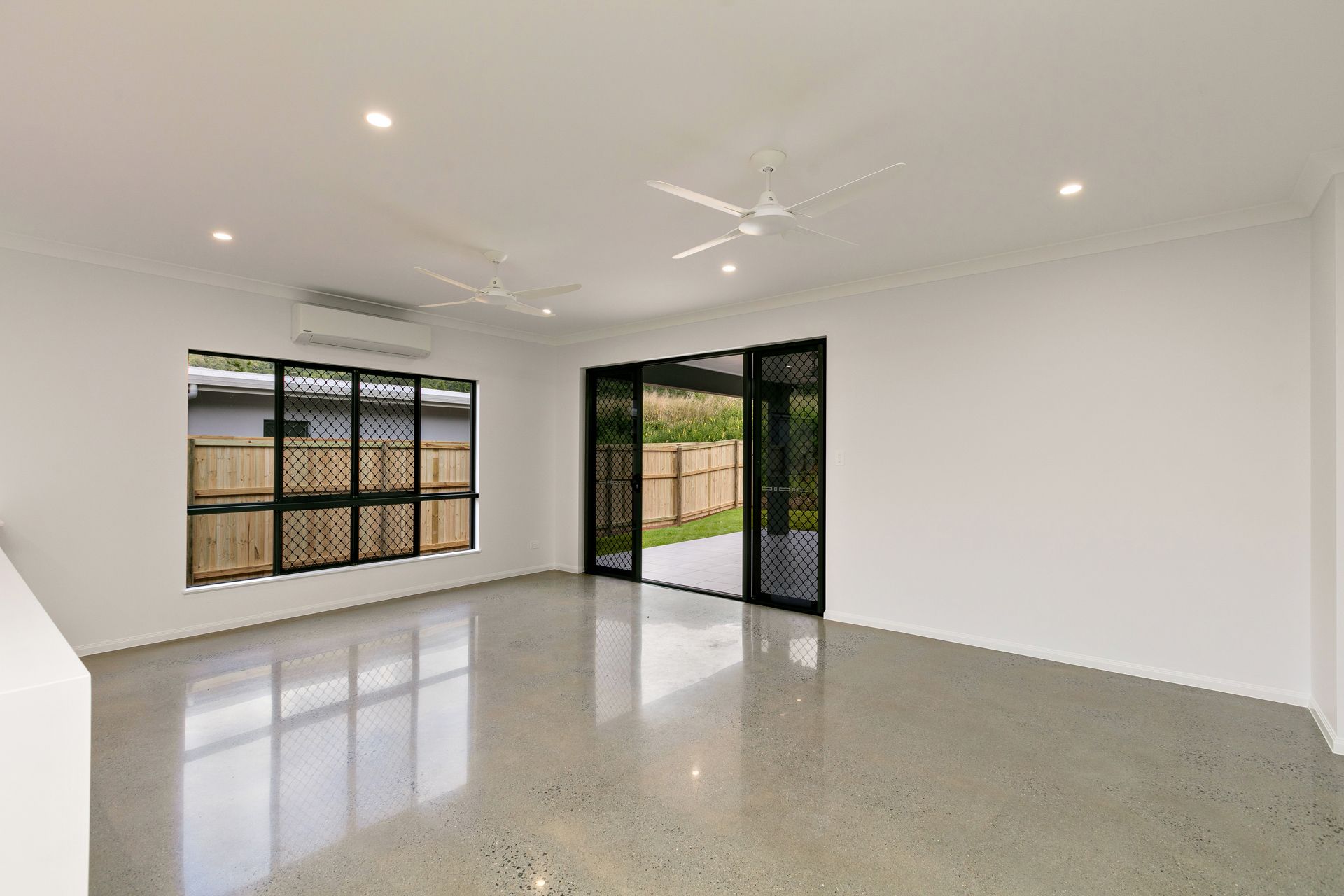 An Empty, Modern Living Space With White Walls — Ashlee Jones Homes in Gordonvale, QLD