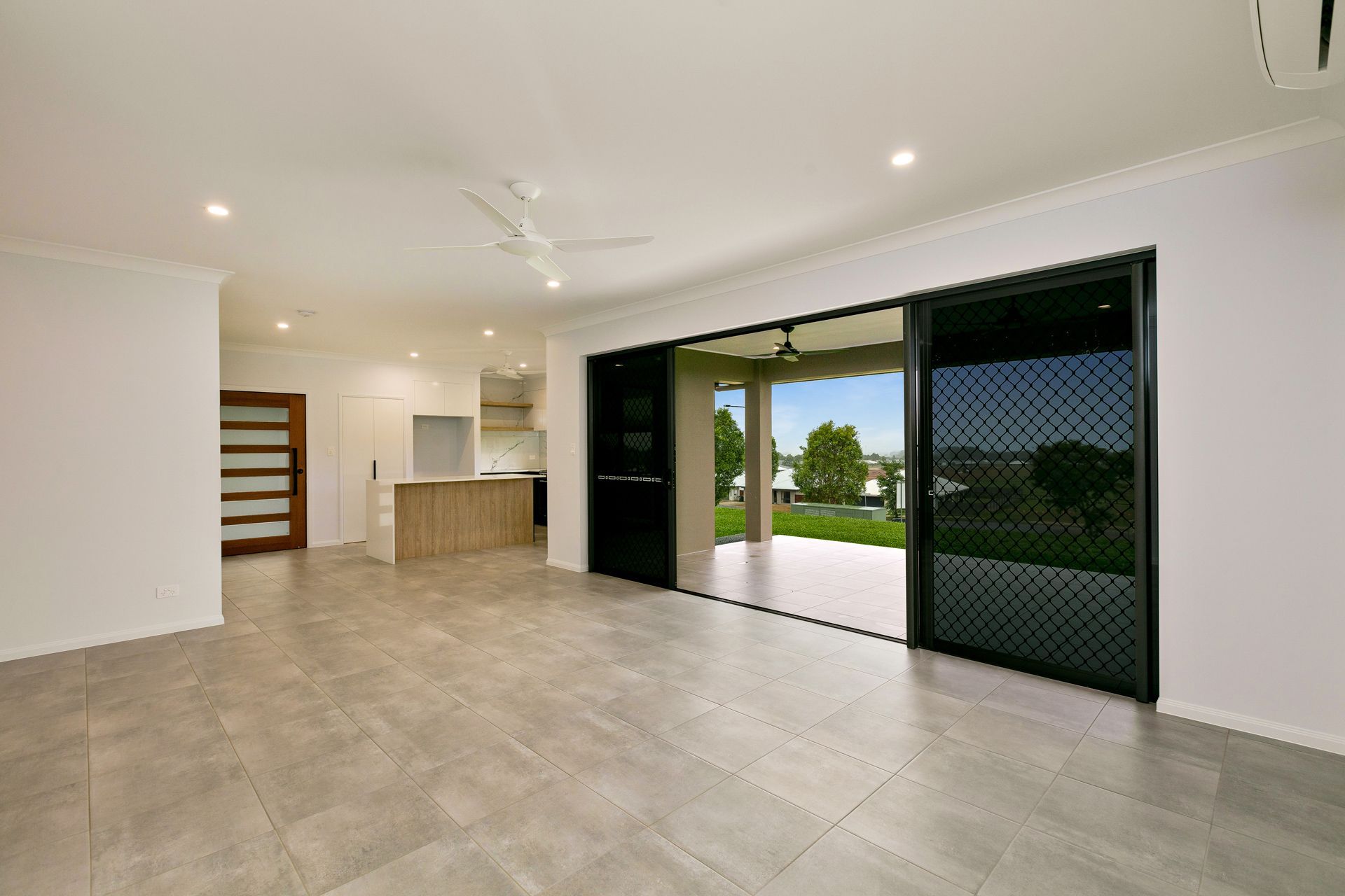 Spacious, Modern Room With Light Grey Tile Floors — Ashlee Jones Homes in Gordonvale, QLD