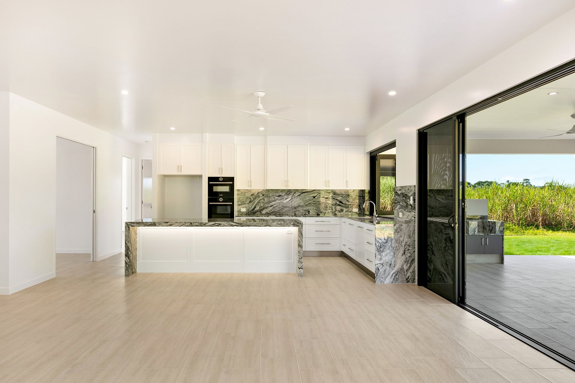 Modern Kitchen With White Cabinets, Marble Countertops — Ashlee Jones Homes in Gordonvale, QLD