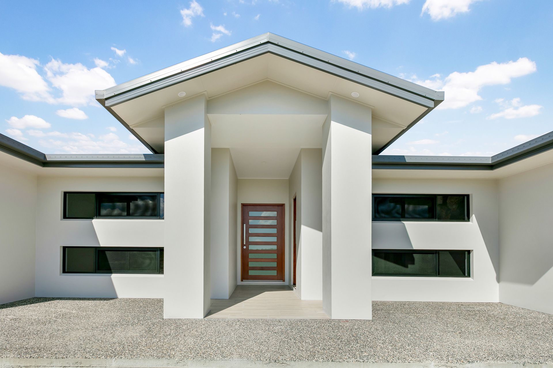 Modern Home Entrance With a Wood-paneled Door — Ashlee Jones Homes in Gordonvale, QLD
