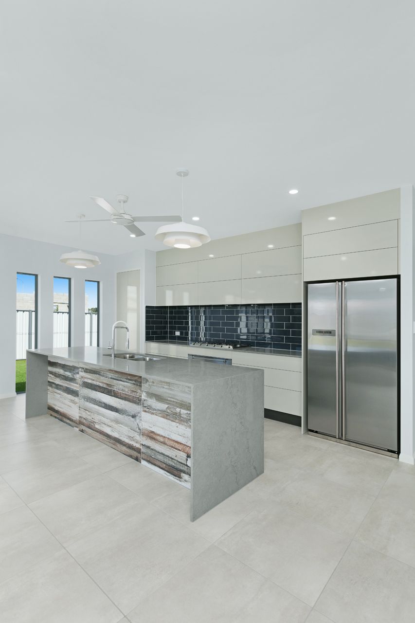 Modern Kitchen With a Long, Stone-fronted Island — Ashlee Jones Homes in Gordonvale, QLD