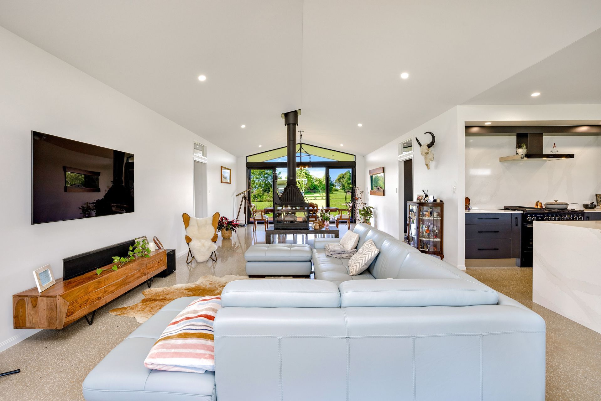 Modern Open-plan Living Room With Light Blue Sectional Sofa — Ashlee Jones Homes in Gordonvale, QLD