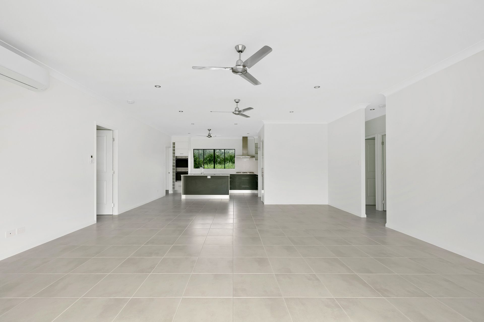 An Open-plan Living and Dining Area With White Walls — Ashlee Jones Homes in Gordonvale, QLD