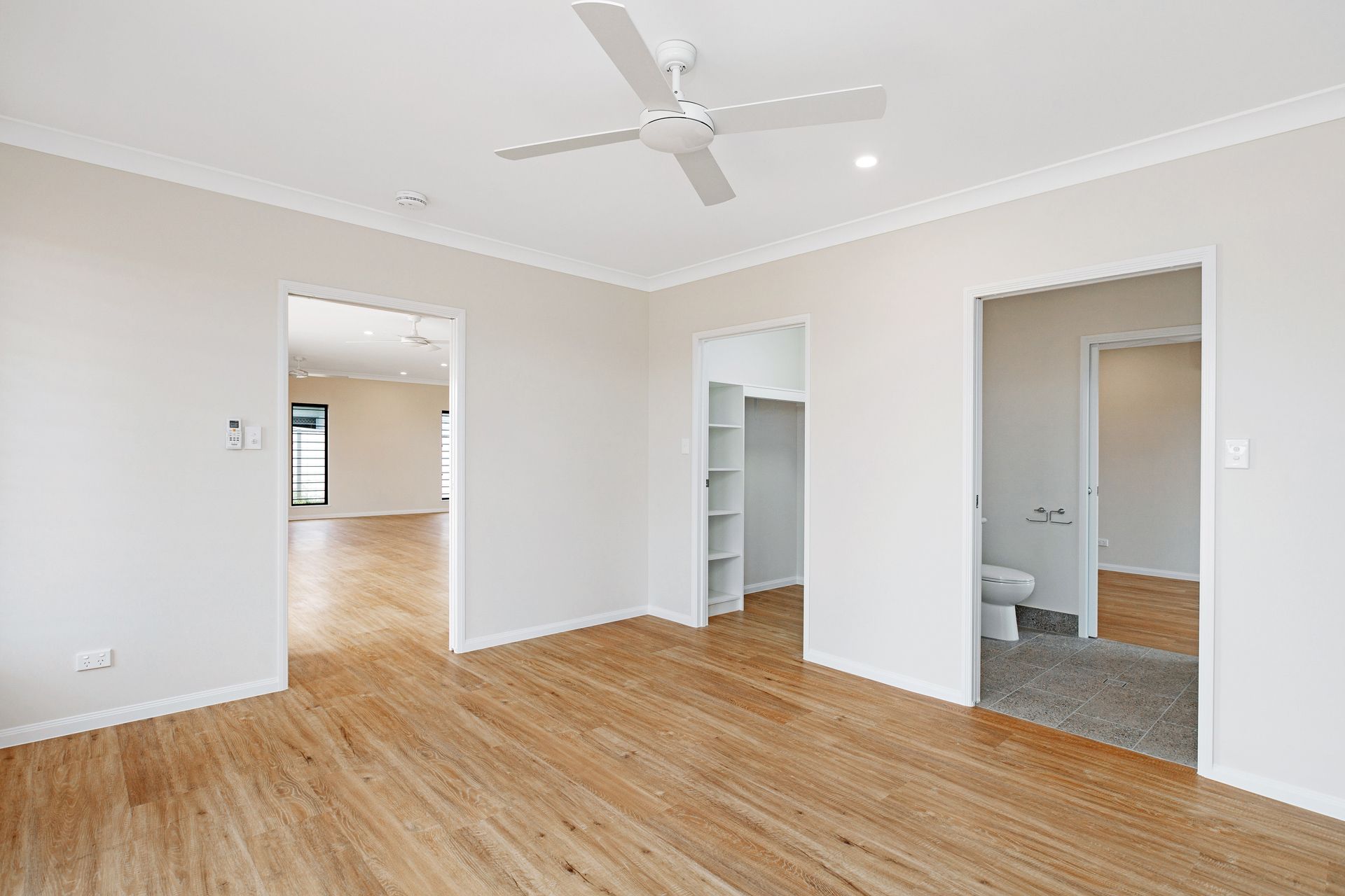A Room With Light Wood Flooring, White Walls — Ashlee Jones Homes in Gordonvale, QLD