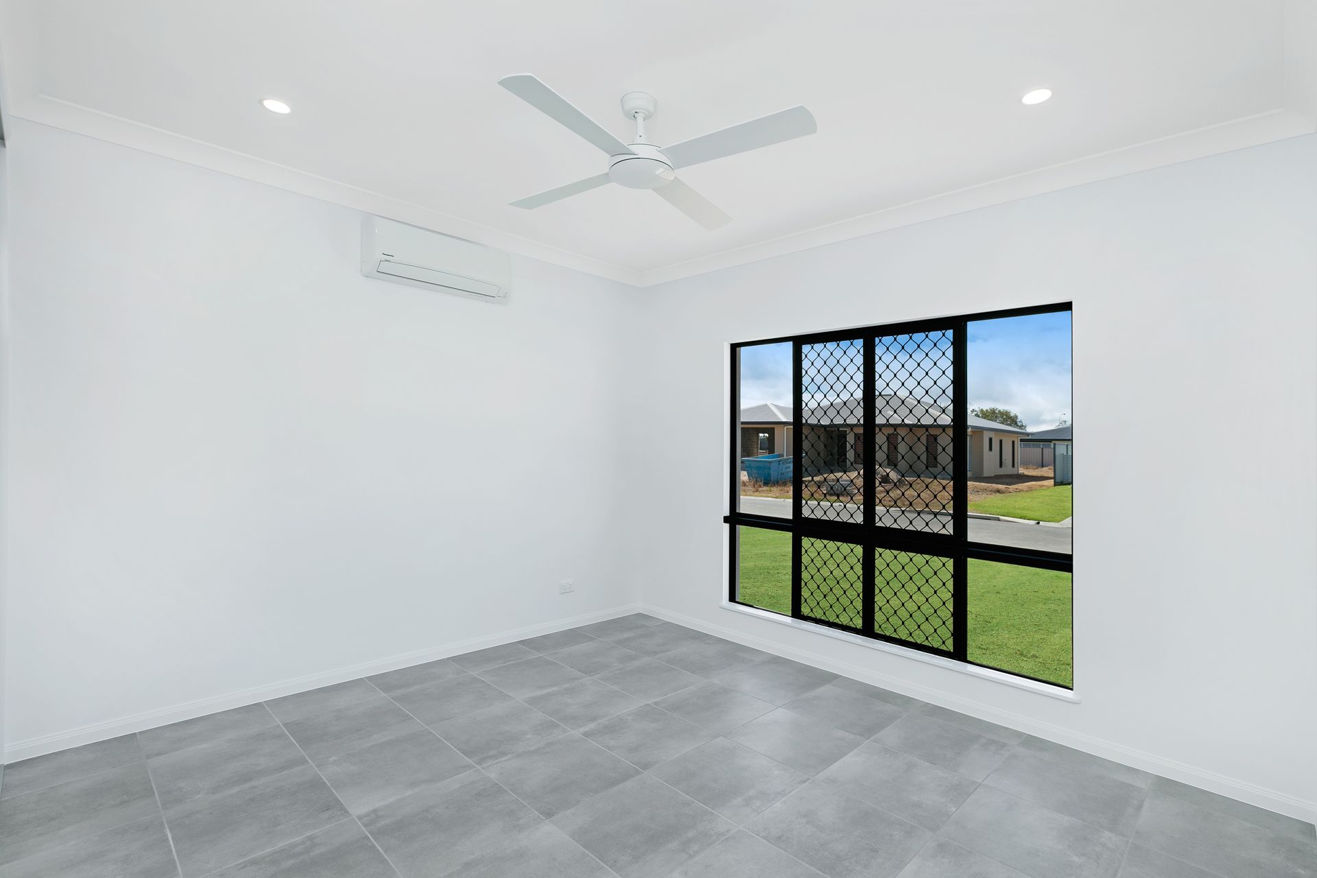 An Empty Room With White Walls, Gray Tile Floors — Ashlee Jones Homes in Gordonvale, QLD