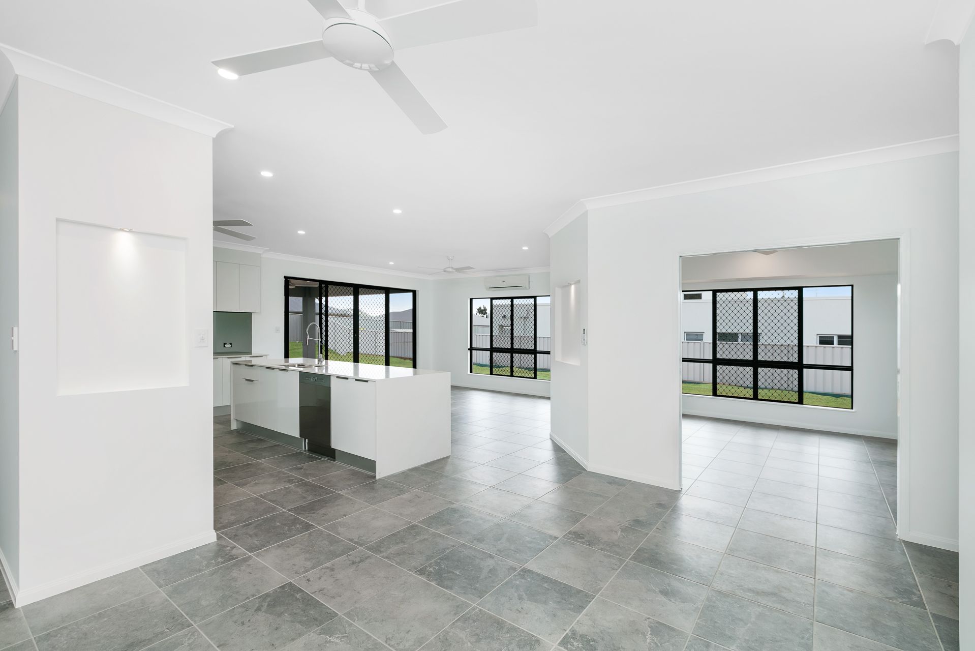 A Spacious, Modern Open-plan Home Interior Featuring White Walls — Ashlee Jones Homes in Gordonvale, QLD