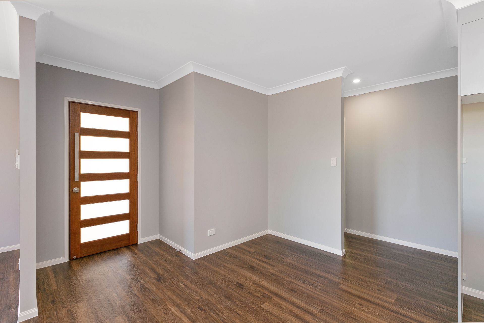 An Empty Entryway With a Wood-framed Glass Door — Ashlee Jones Homes in Gordonvale, QLD