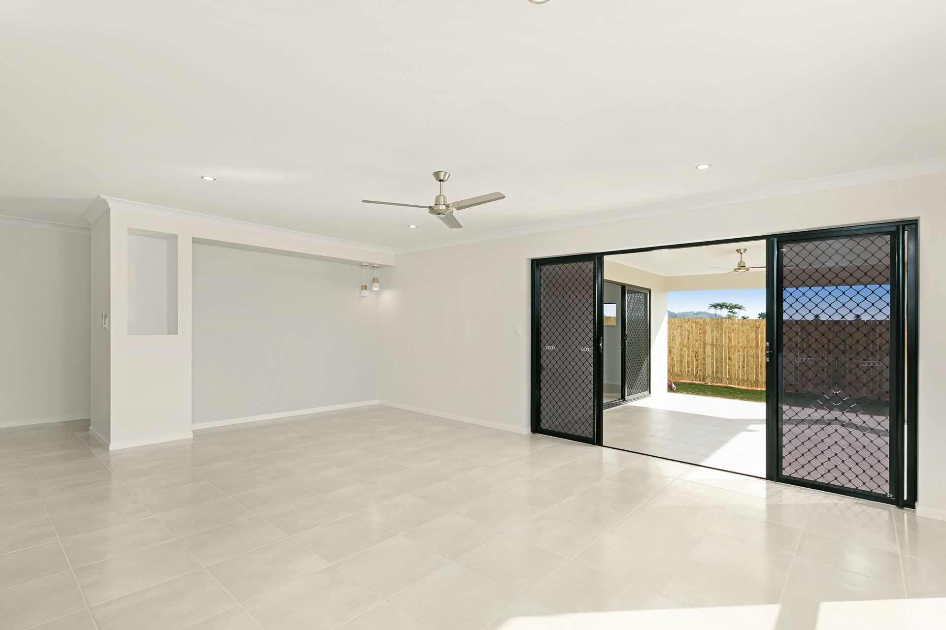 An Open-plan Living Room With White Walls — Ashlee Jones Homes in Gordonvale, QLD