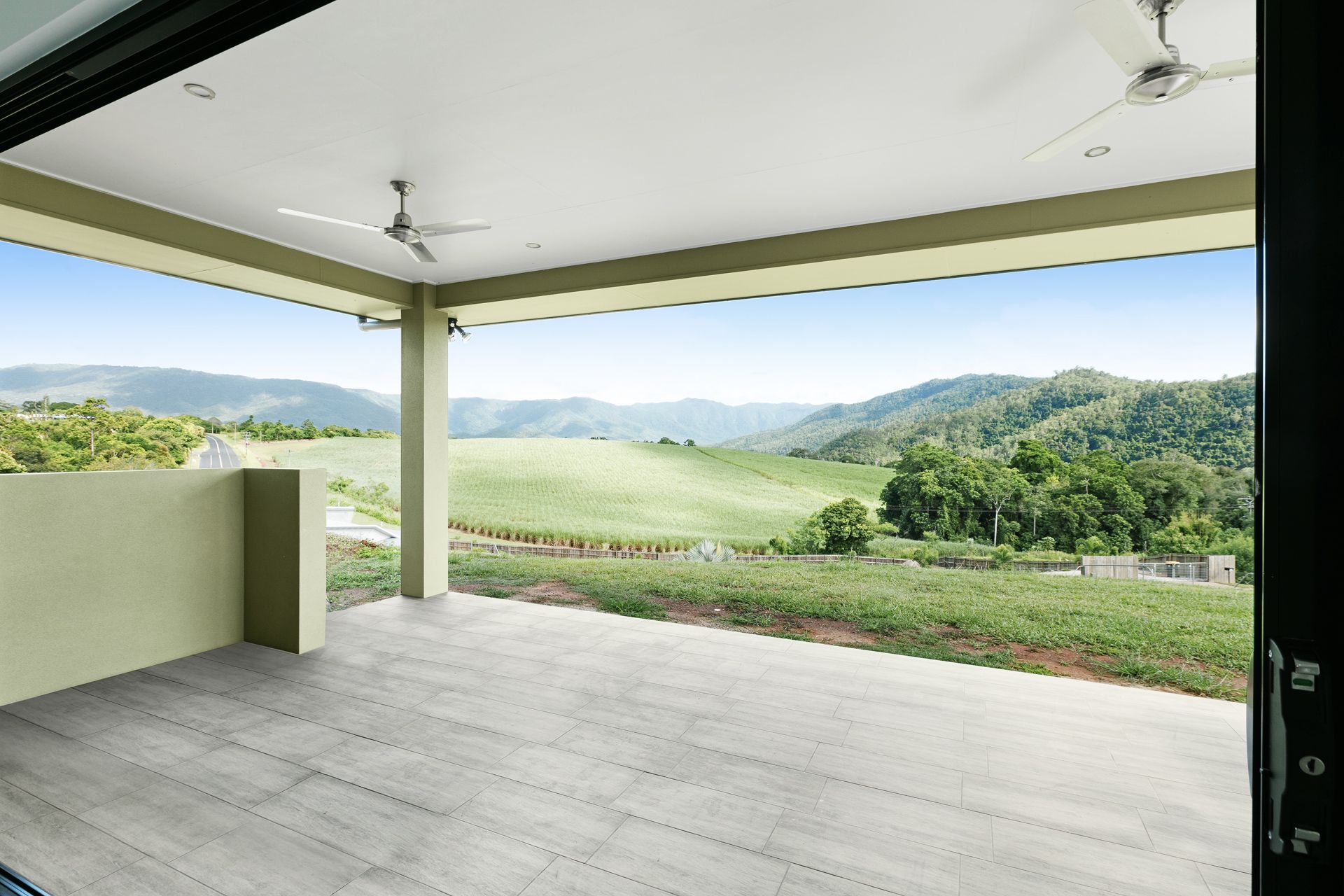 Covered Patio With Grey Flooring, Ceiling Fans — Ashlee Jones Homes in Gordonvale, QLD