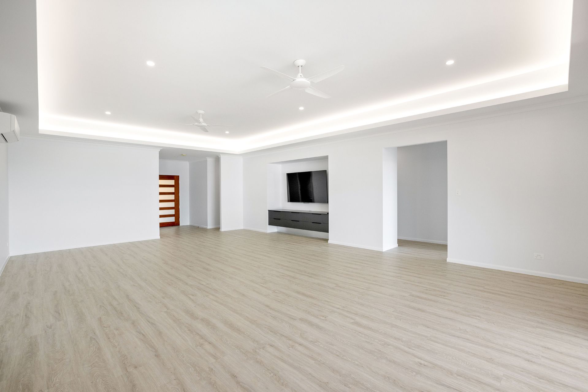 A Spacious, Minimalist Living Room With White Walls — Ashlee Jones Homes in Gordonvale, QLD
