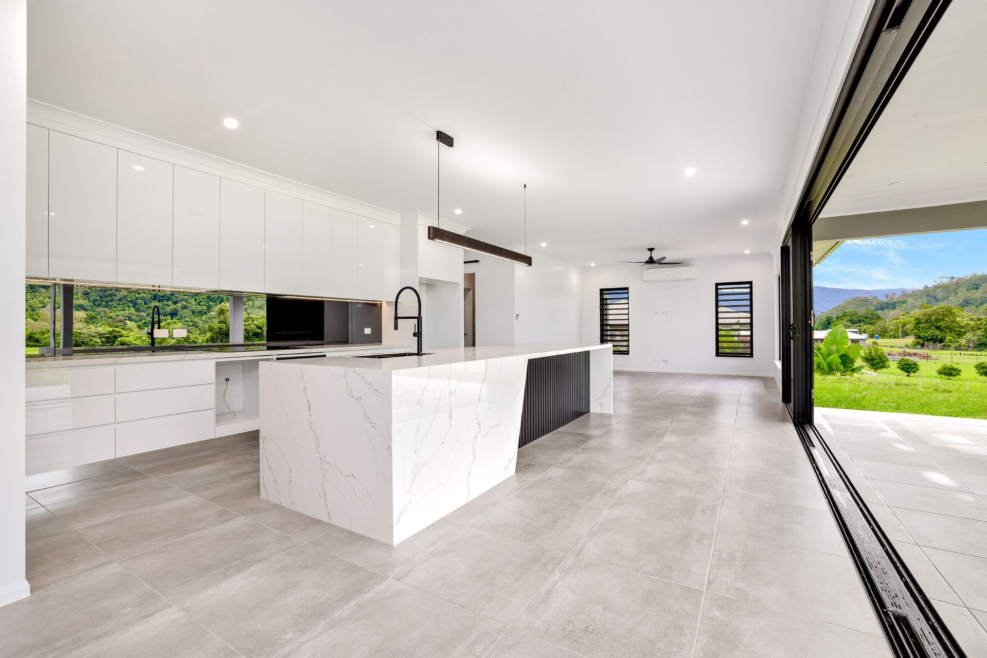 A Modern, Minimalist Kitchen With White Marble Counters — Ashlee Jones Homes in Gordonvale, QLD