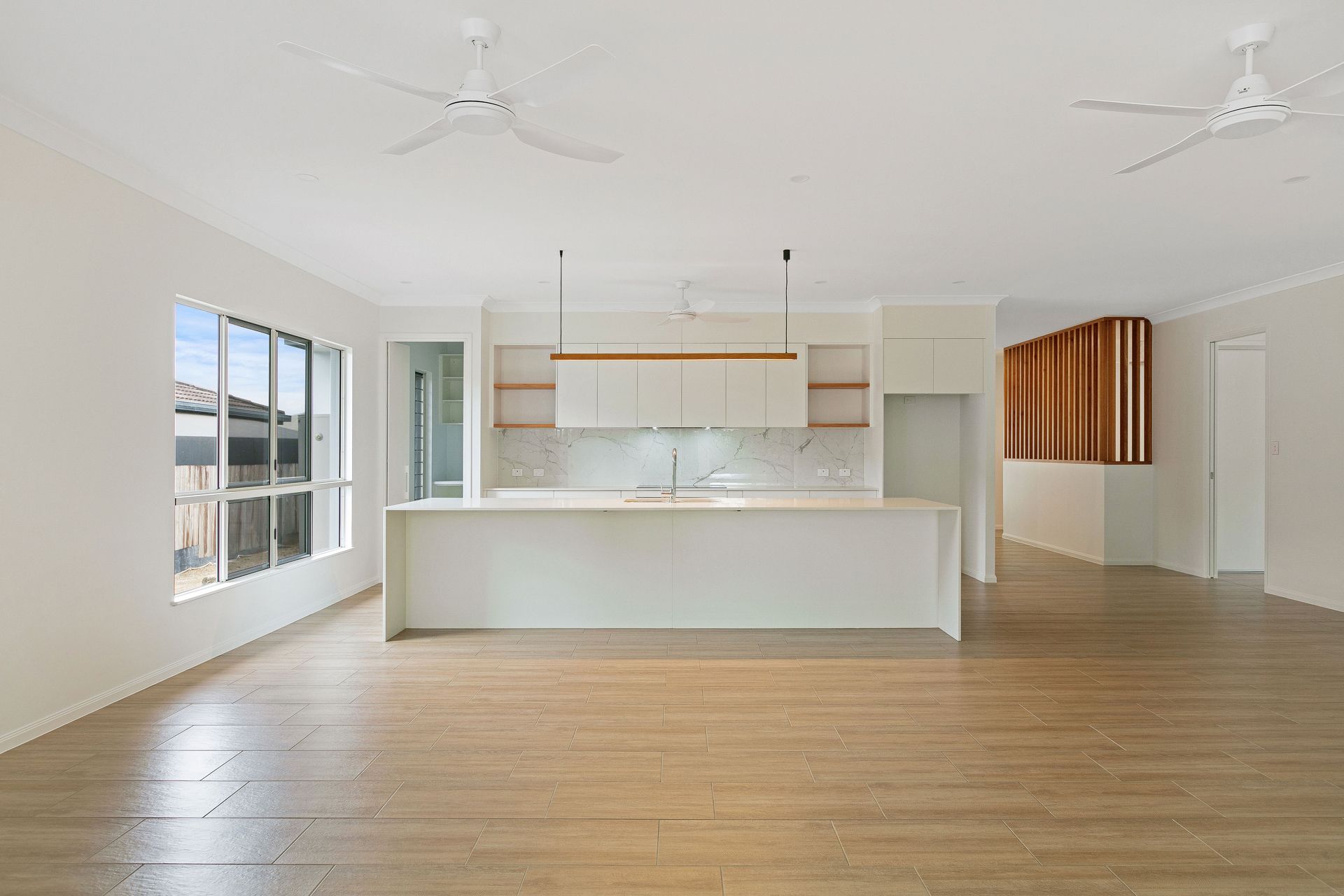 An Open-plan, Modern Kitchen With a Large White Island — Ashlee Jones Homes in Gordonvale, QLD