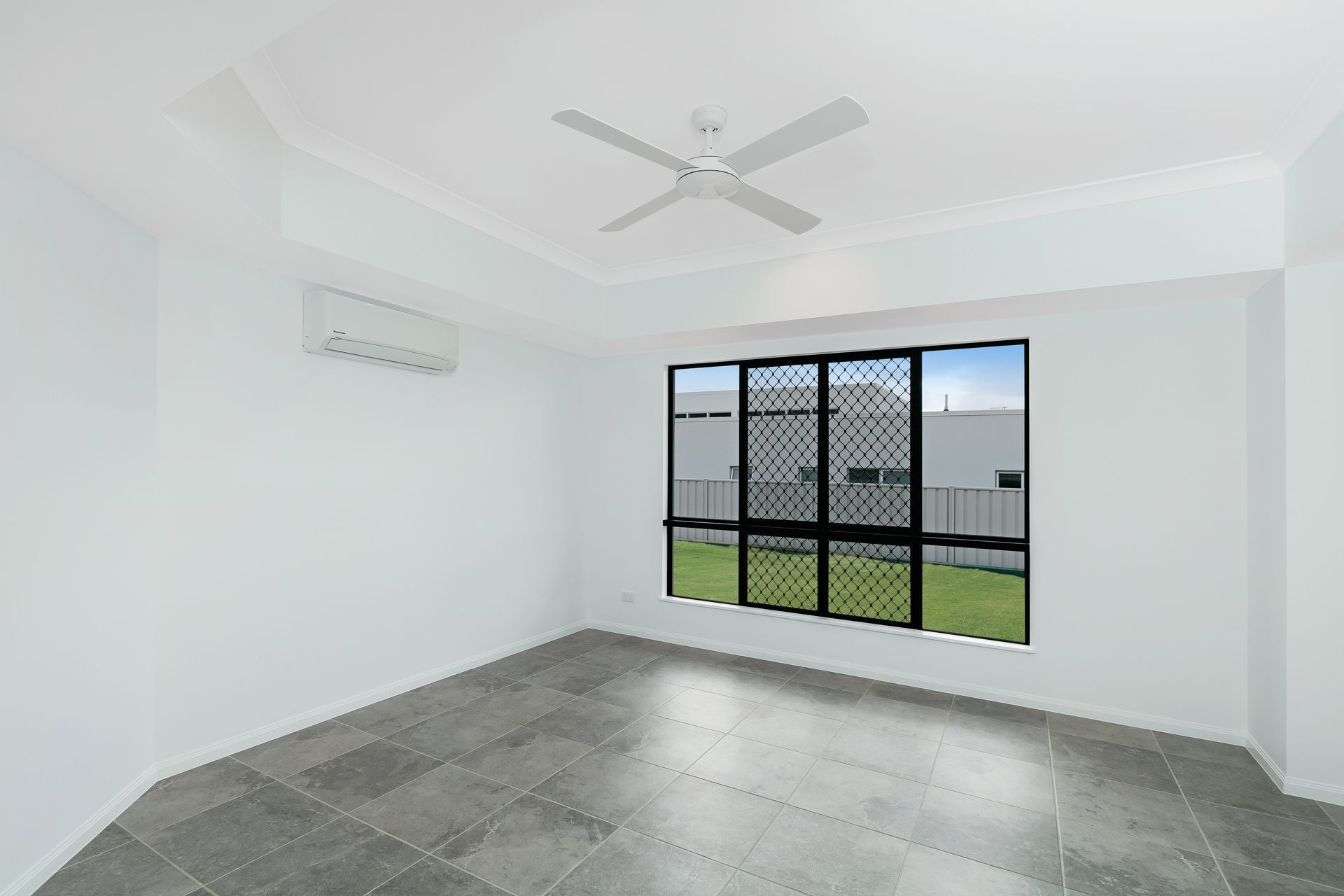 A Bright, Empty Room With Light Grey Walls — Ashlee Jones Homes in Gordonvale, QLD