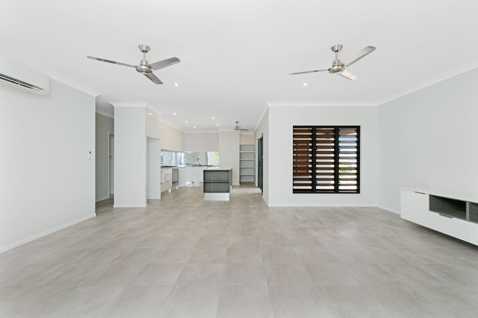 Spacious, Bright Living Area With White Walls, Grey Tile Flooring — Ashlee Jones Homes in Gordonvale, QLD