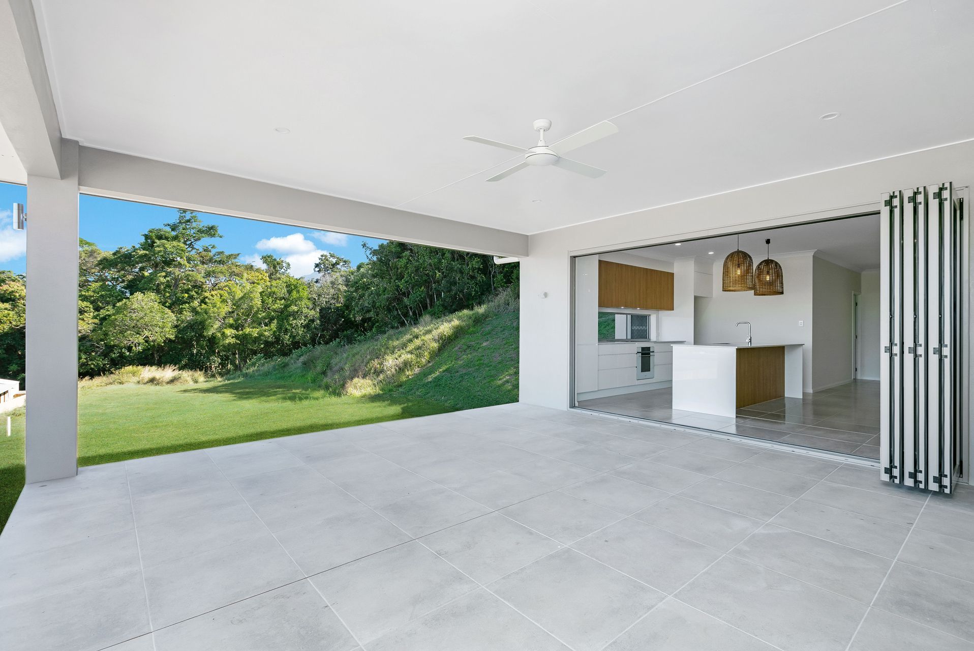A Spacious Covered Patio With Large White Tiles — Ashlee Jones Homes in Gordonvale, QLD