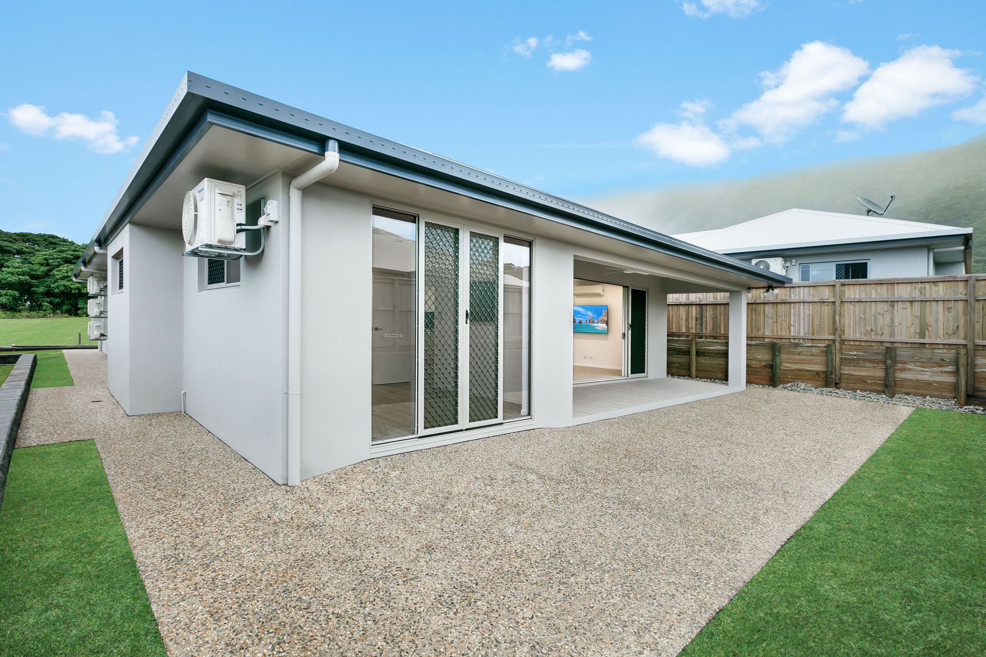 A Modern, Light-gray, Single-story House Featuring a Gravel Patio — Ashlee Jones Homes in Gordonvale, QLD