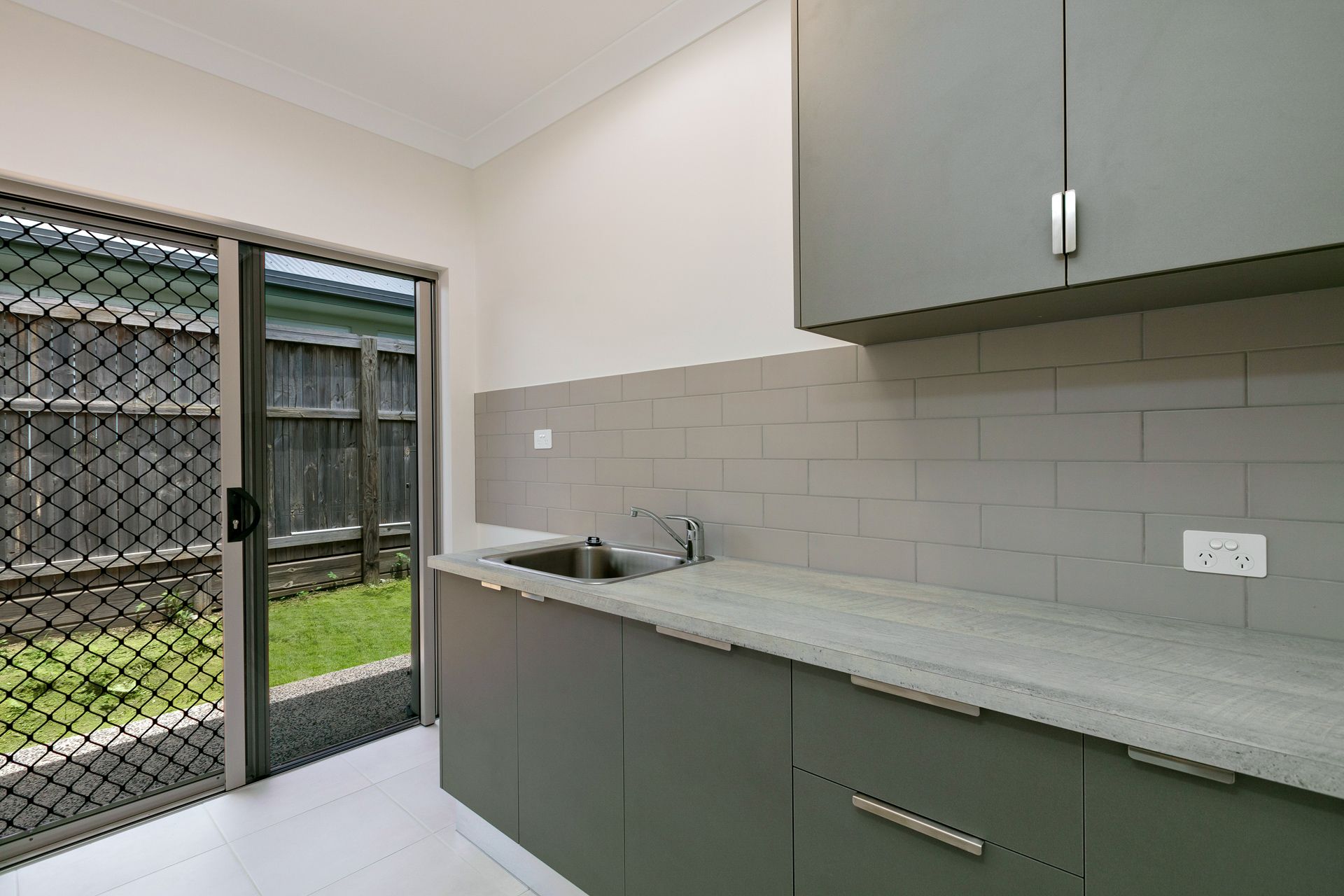 Modern Kitchenette With Grey Cabinetry, Stone Countertop — Ashlee Jones Homes in Gordonvale, QLD