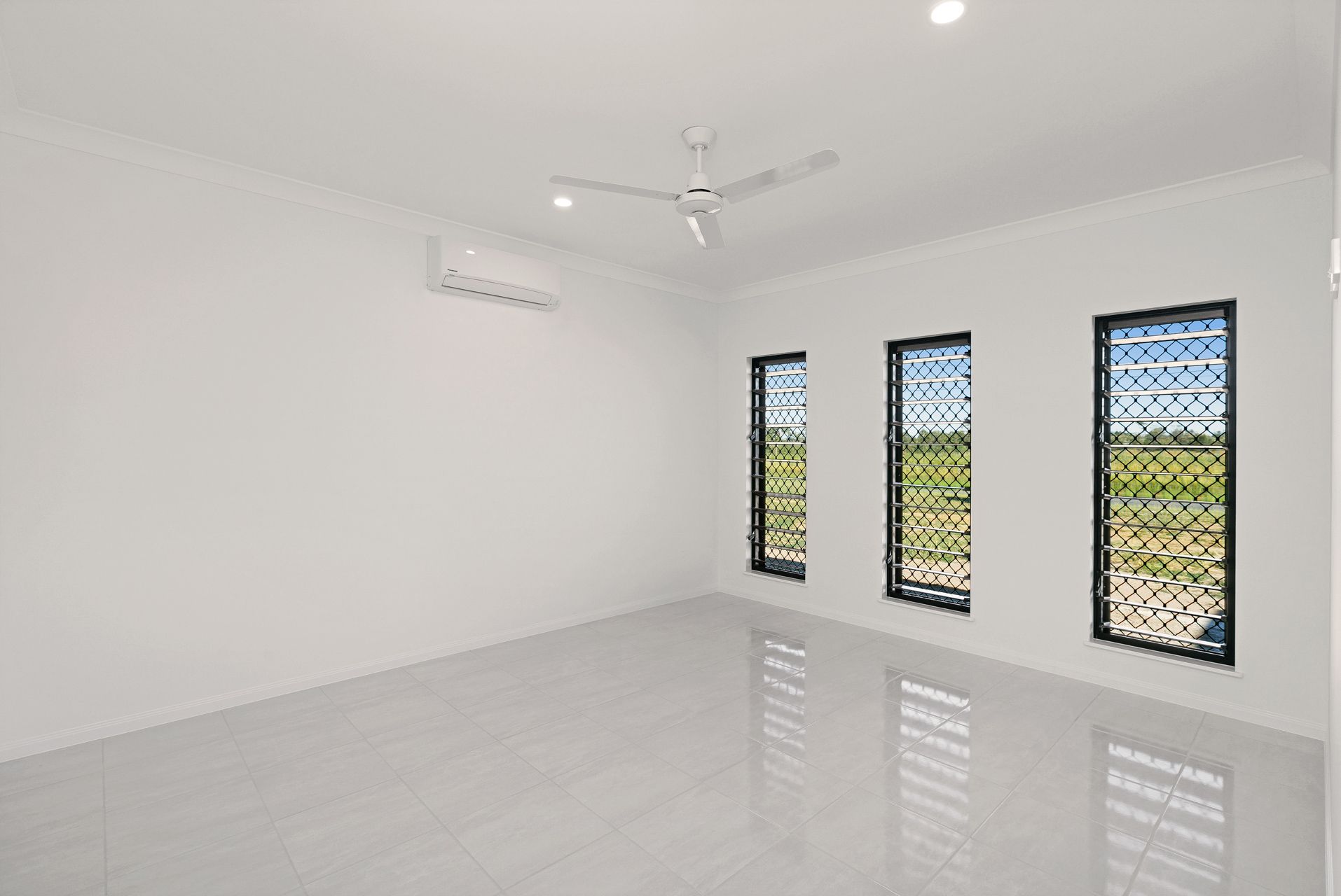 An Empty Room With White Walls, Tiled Floors — Ashlee Jones Homes in Gordonvale, QLD