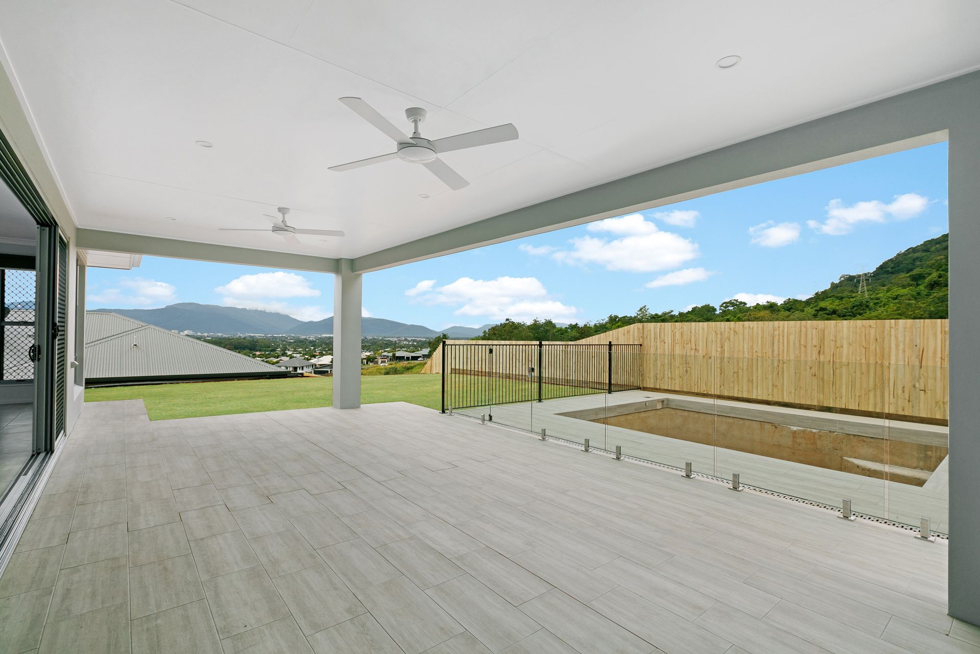 A Covered Outdoor Patio With Light Wood-look Flooring — Ashlee Jones Homes in Gordonvale, QLD