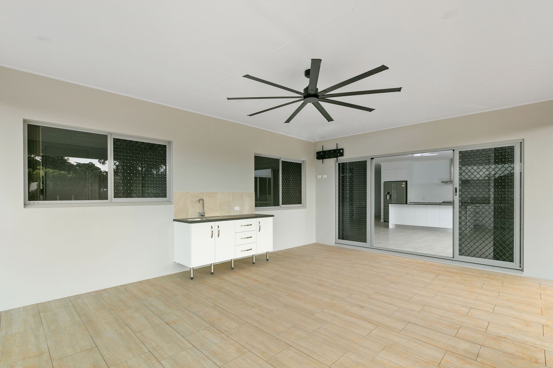 A Spacious Outdoor Patio With Light Wood-look Floors — Ashlee Jones Homes in Gordonvale, QLD