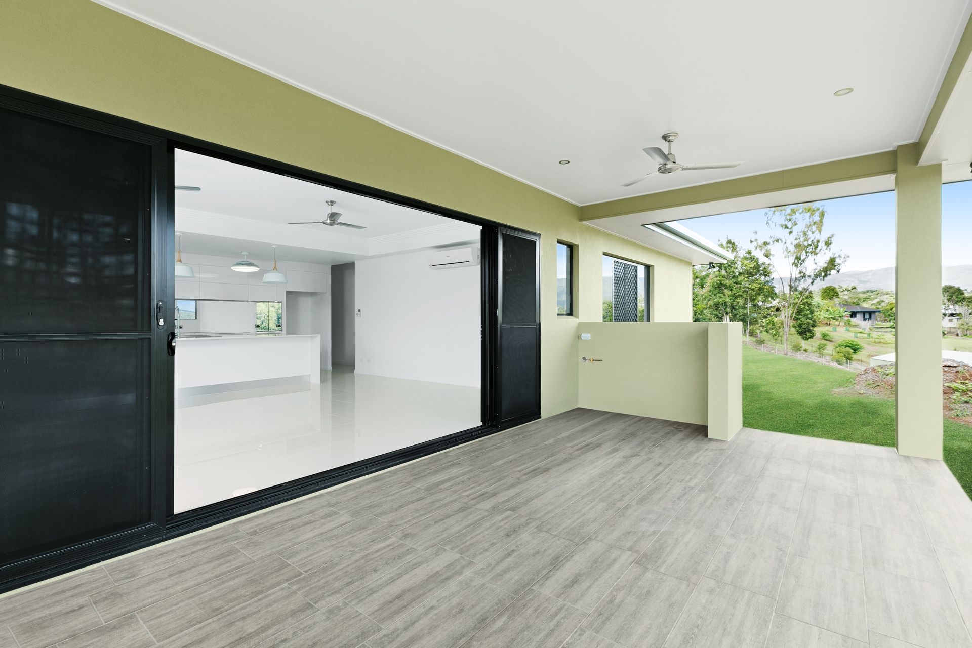A Covered Patio With Light-wood-look Flooring — Ashlee Jones Homes in Gordonvale, QLD
