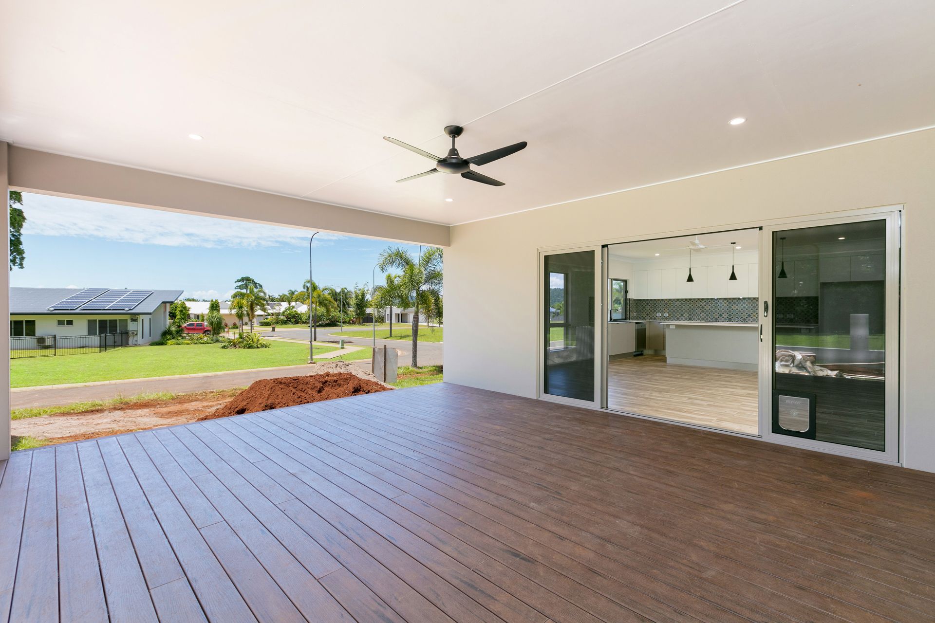 A Spacious Outdoor Wooden Deck Under a Covered Patio — Ashlee Jones Homes in Gordonvale, QLD