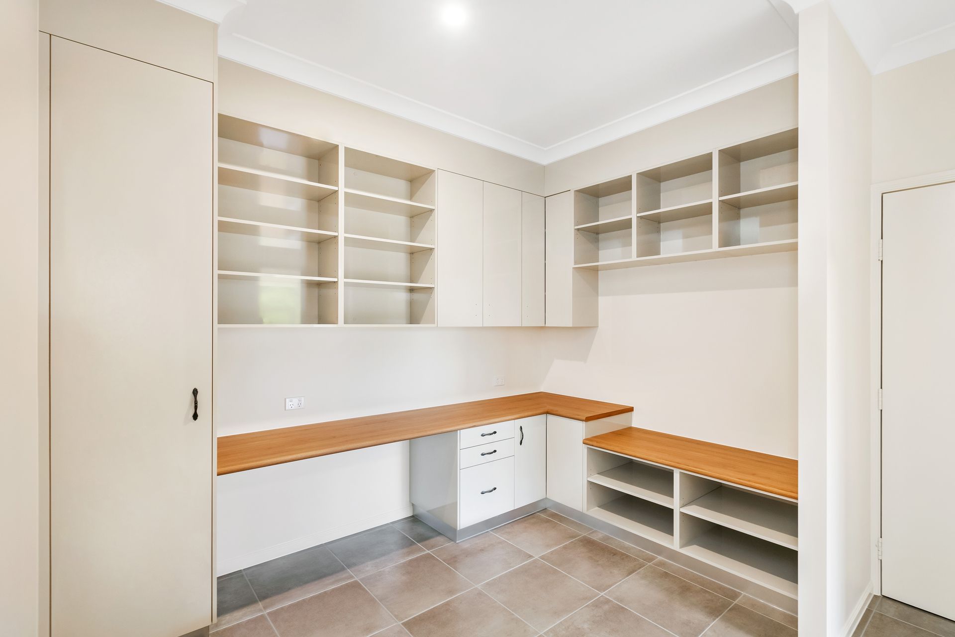 A Modern Home Office or Pantry With Beige Cabinetry — Ashlee Jones Homes in Gordonvale, QLD