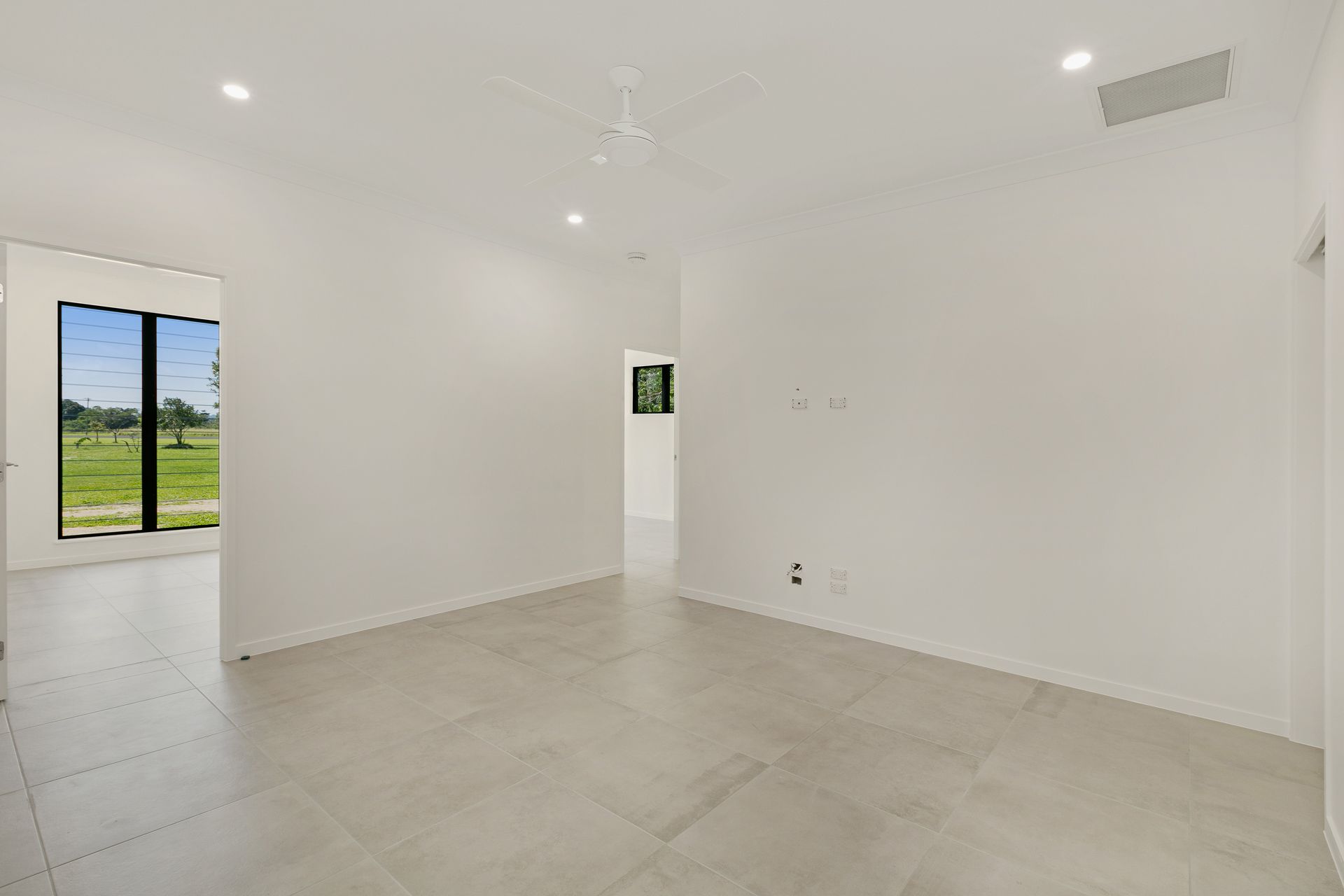 A Bright, Minimalist Room With Plain White Walls — Ashlee Jones Homes in Gordonvale, QLD