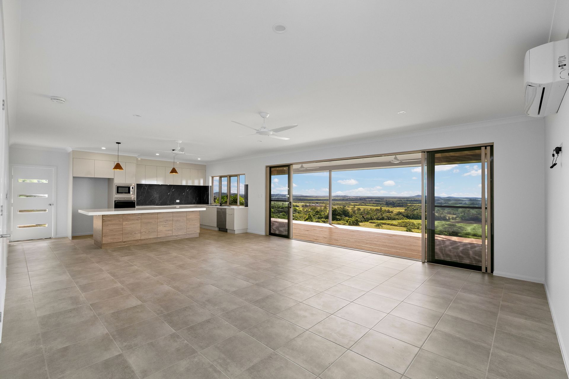Spacious Open-plan Living Room With Light Tile Floors — Ashlee Jones Homes in Gordonvale, QLD