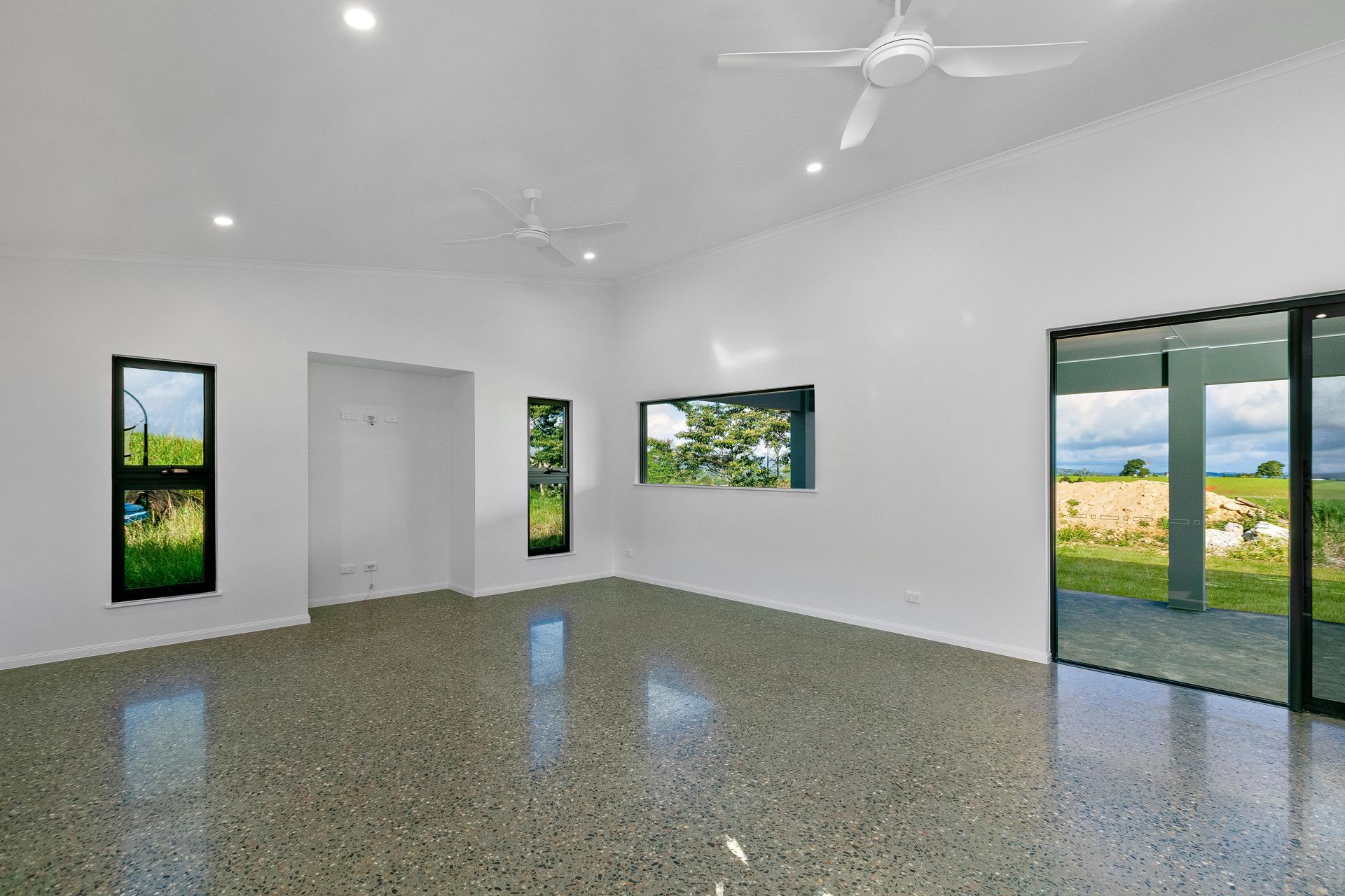 A Bright, Minimalist Room Featuring White Walls — Ashlee Jones Homes in Gordonvale, QLD